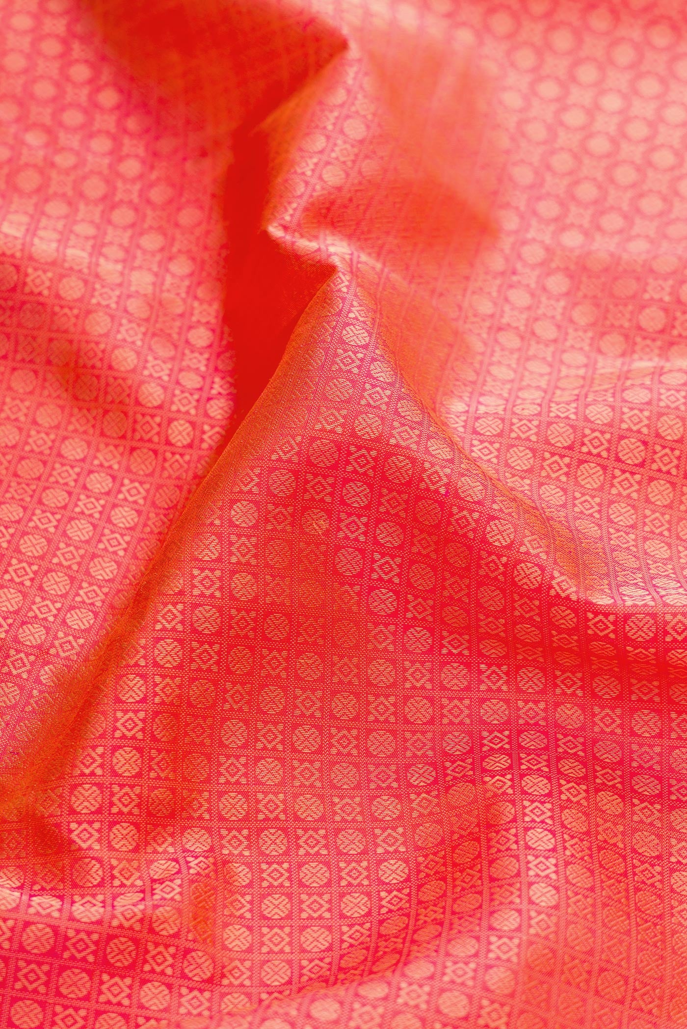 Close up of Pure Silk Pure Zari Coral Dual Tone Kanjivaram Saree with Jacquard design on the body and Zari Border.  displaying folds