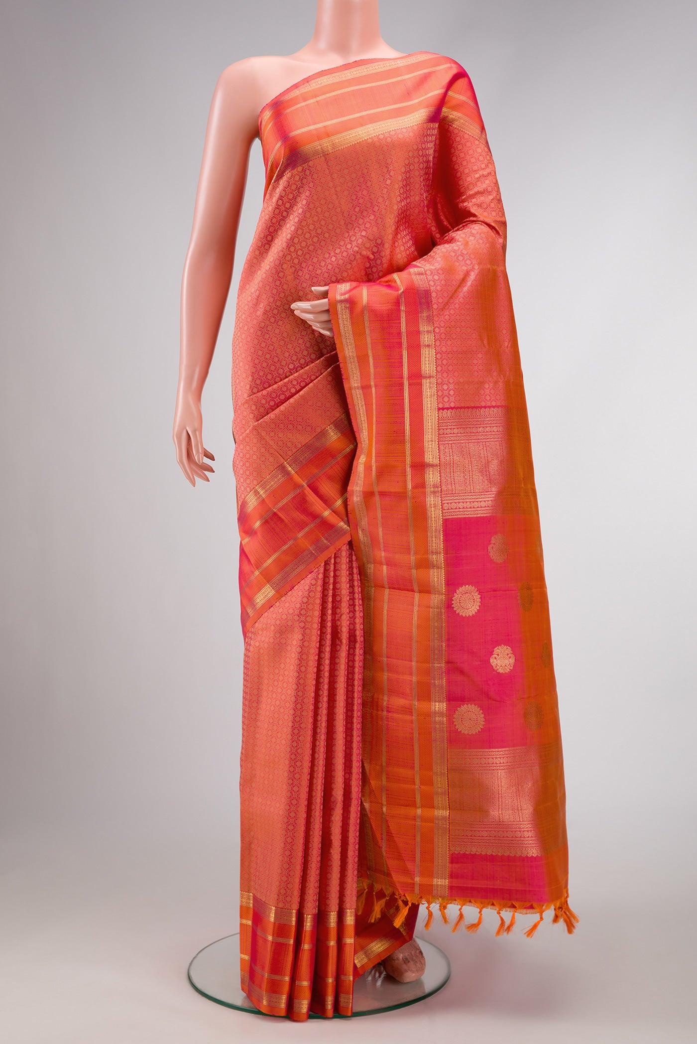 Pure Silk Pure Zari Coral Dual Tone Kanjivaram Saree with Jacquard design on the body and Zari Border.  displayed on a mannequin