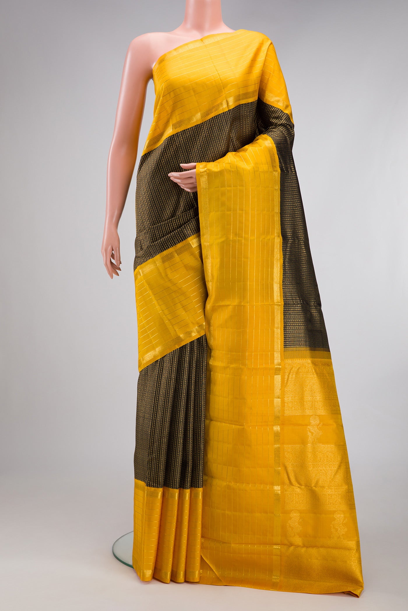 Black Kanchipuram Silk Saree with Zari Brocade on the body and Zari Border.  displayed on a mannequin