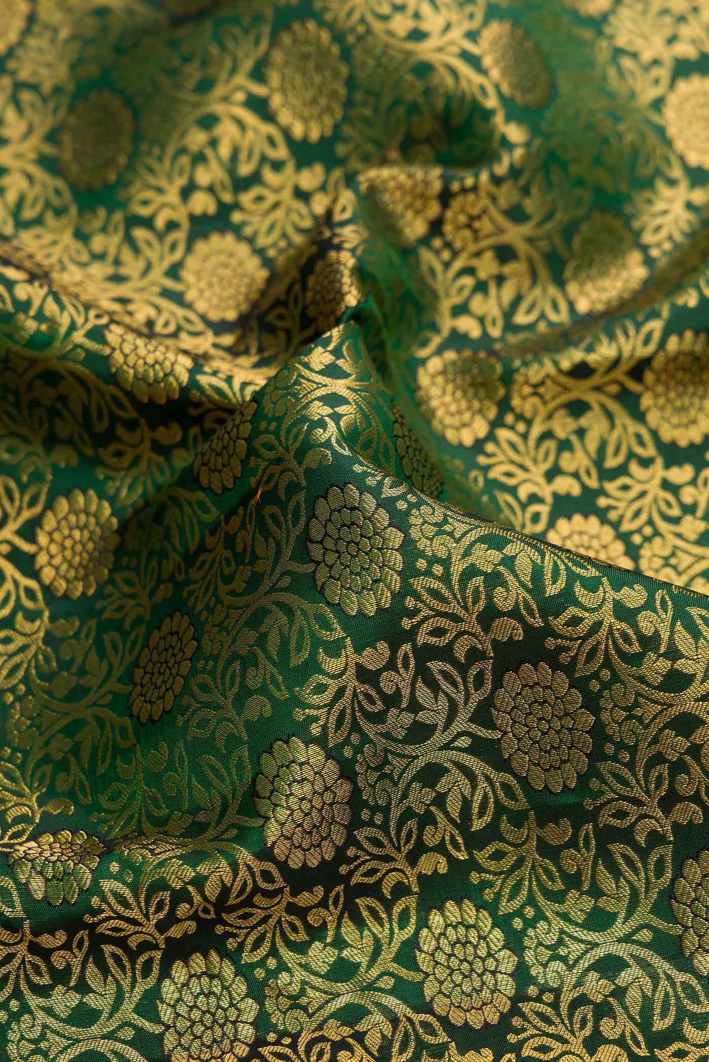 Close up of Bottle Green Dual Tone Kanchipuram Silk Saree with Zari Brocade on the body and Zari Border.  displaying folds