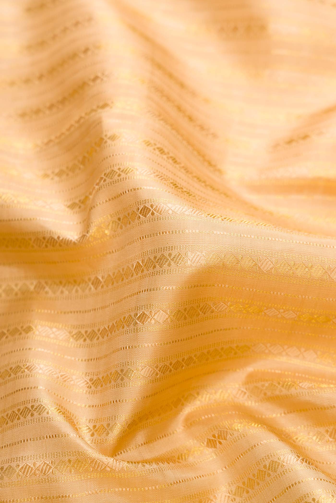 Close up of Sandal Dual Tone Kanchipuram Silk Saree with Zari Brocade on the body and Zari And Thread Border.  displaying folds