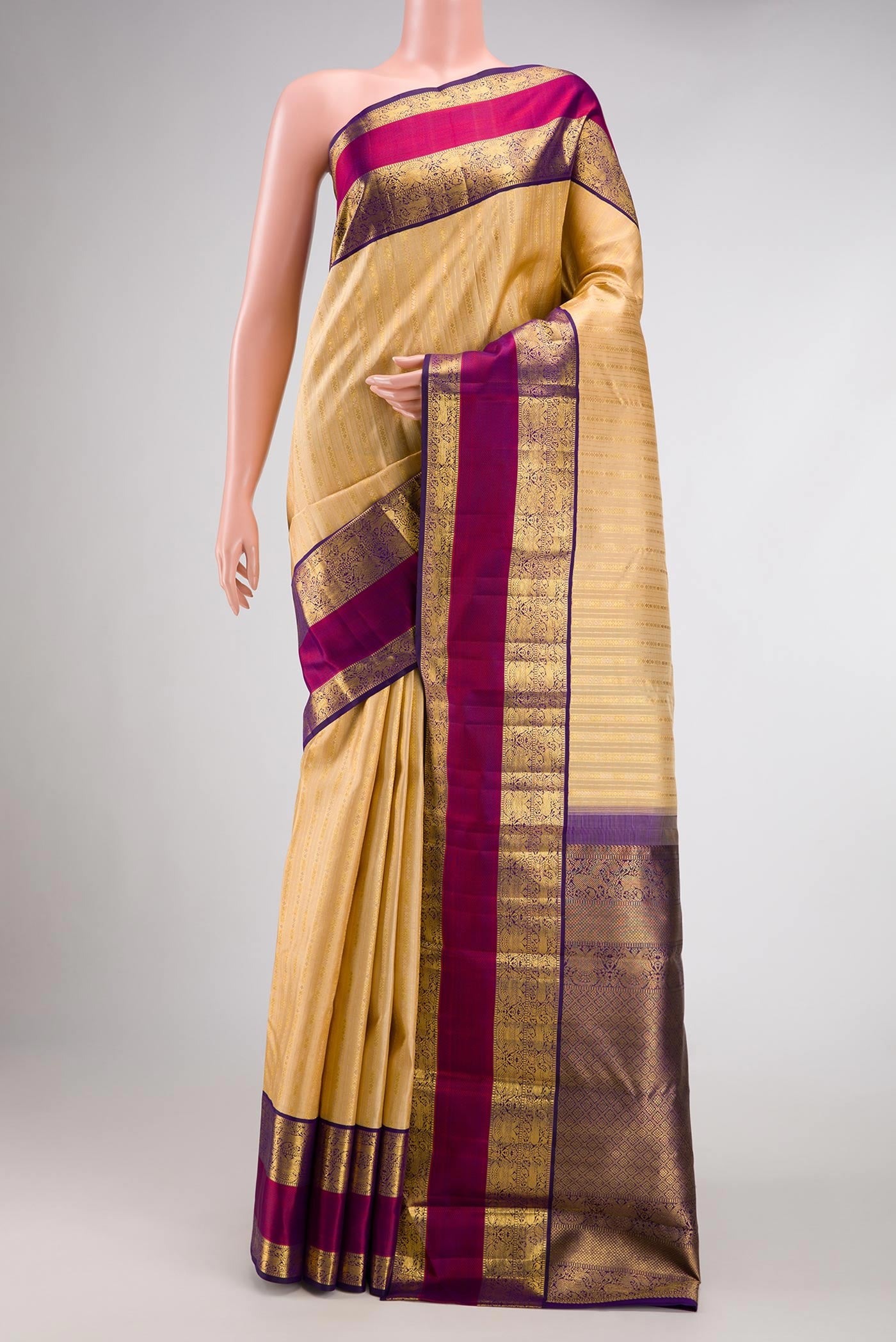 Sandal Dual Tone Kanchipuram Silk Saree with Zari Brocade on the body and Zari And Thread Border.  displayed on a mannequin