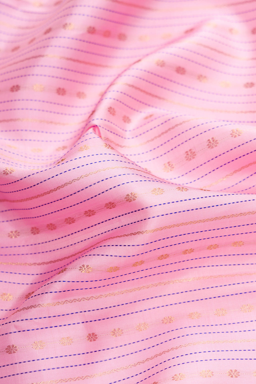 Close up of Pure Silk Pure Zari Pink Dual Tone Kanchipuram Saree with Stripes on the body and Zari Border.  displaying folds