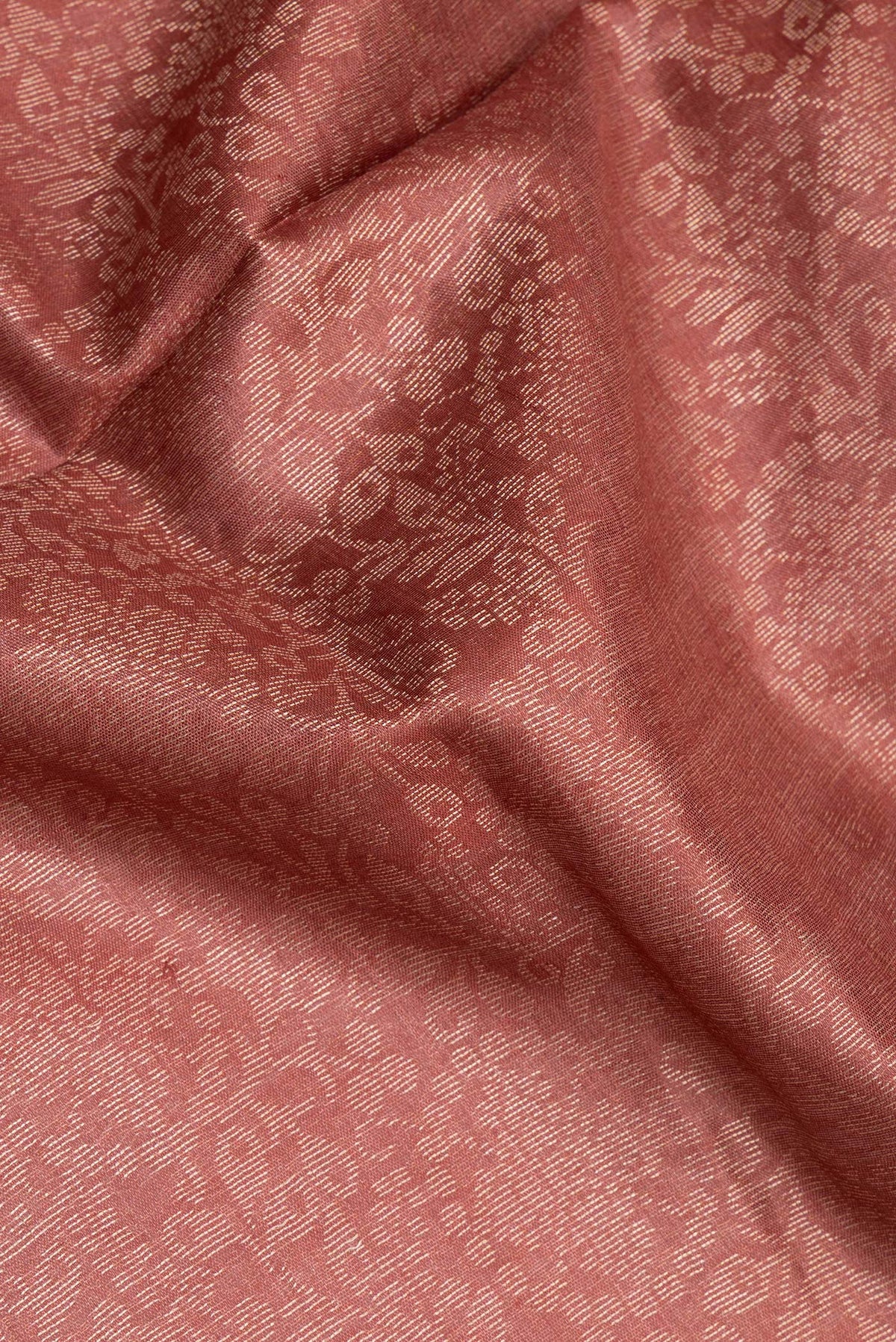 Close up of Pure Silk Rose Gold Dual Tone Tussar Saree with Zari Brocade on the body and Zari Border.  displaying folds