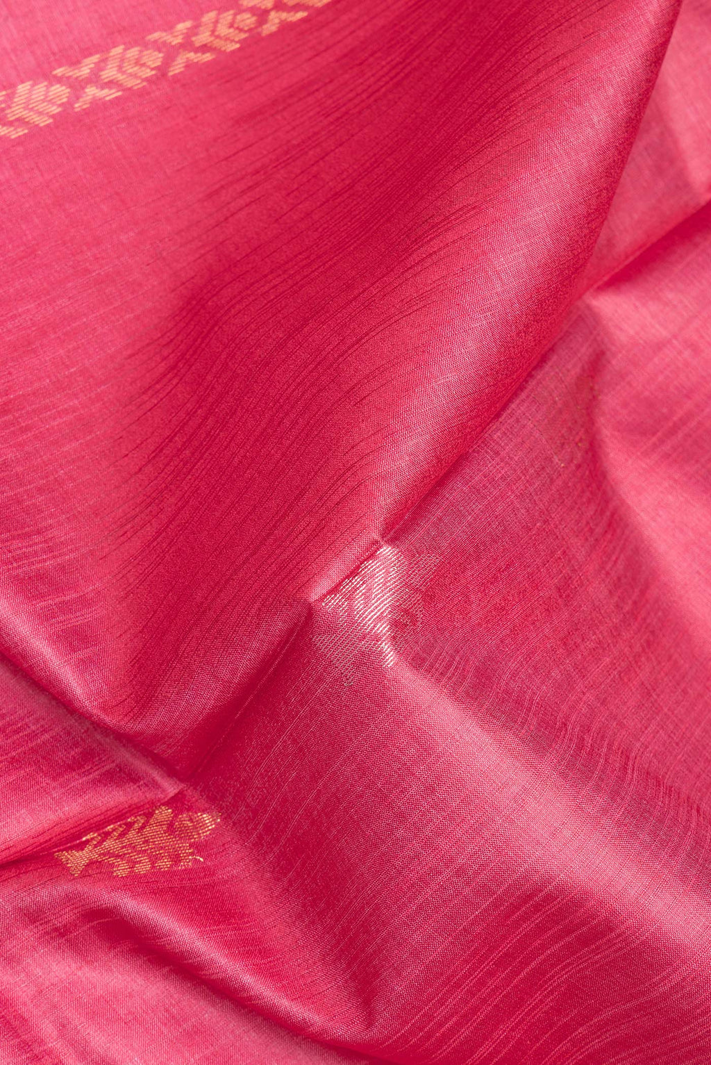 Close up of Pure Silk Pink Dual Tone Tussar Saree with Zari Butta on the body and Zari Border.  displaying folds