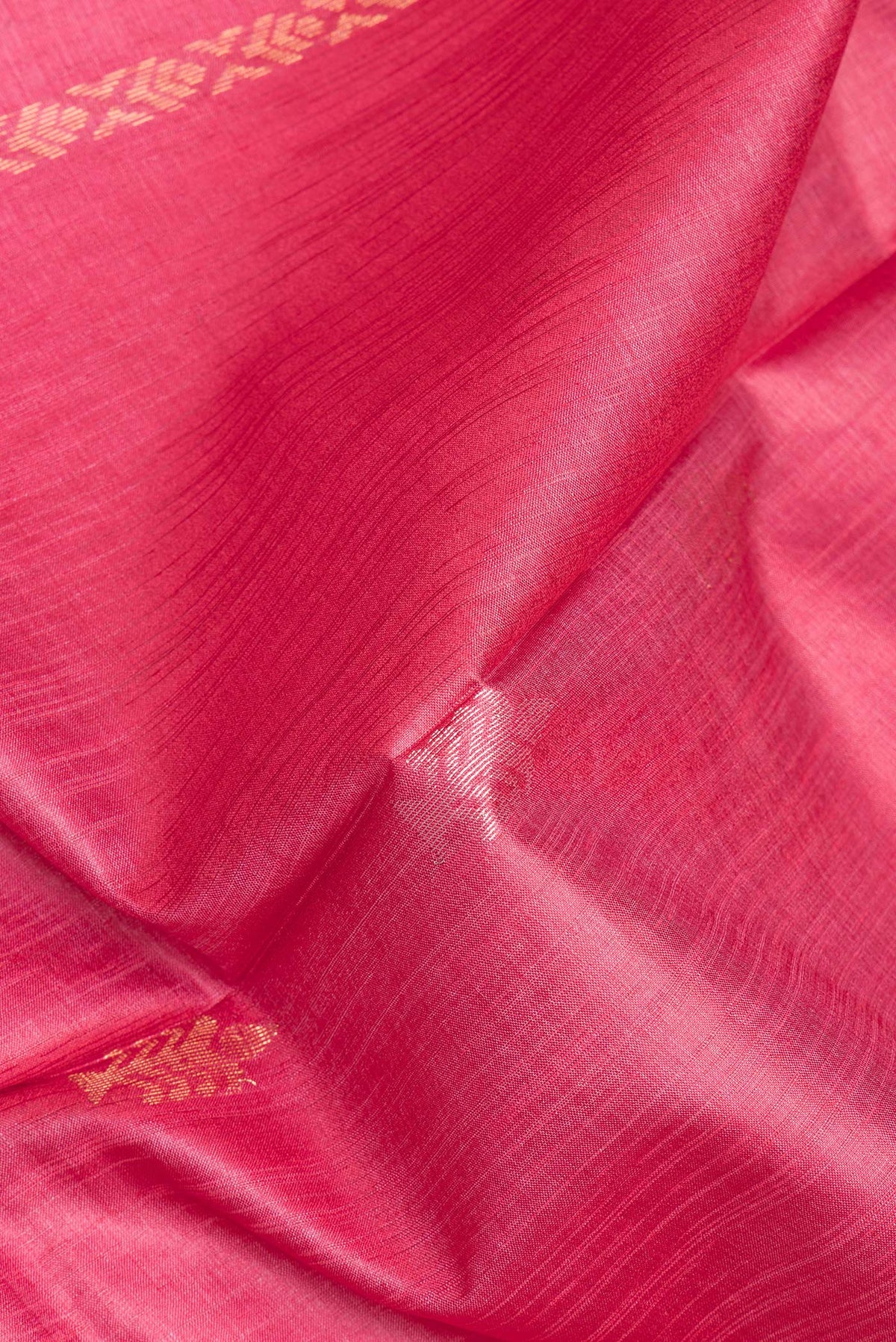 Close up of Pure Silk Pink Dual Tone Tussar Saree with Zari Butta on the body and Zari Border.  displaying folds