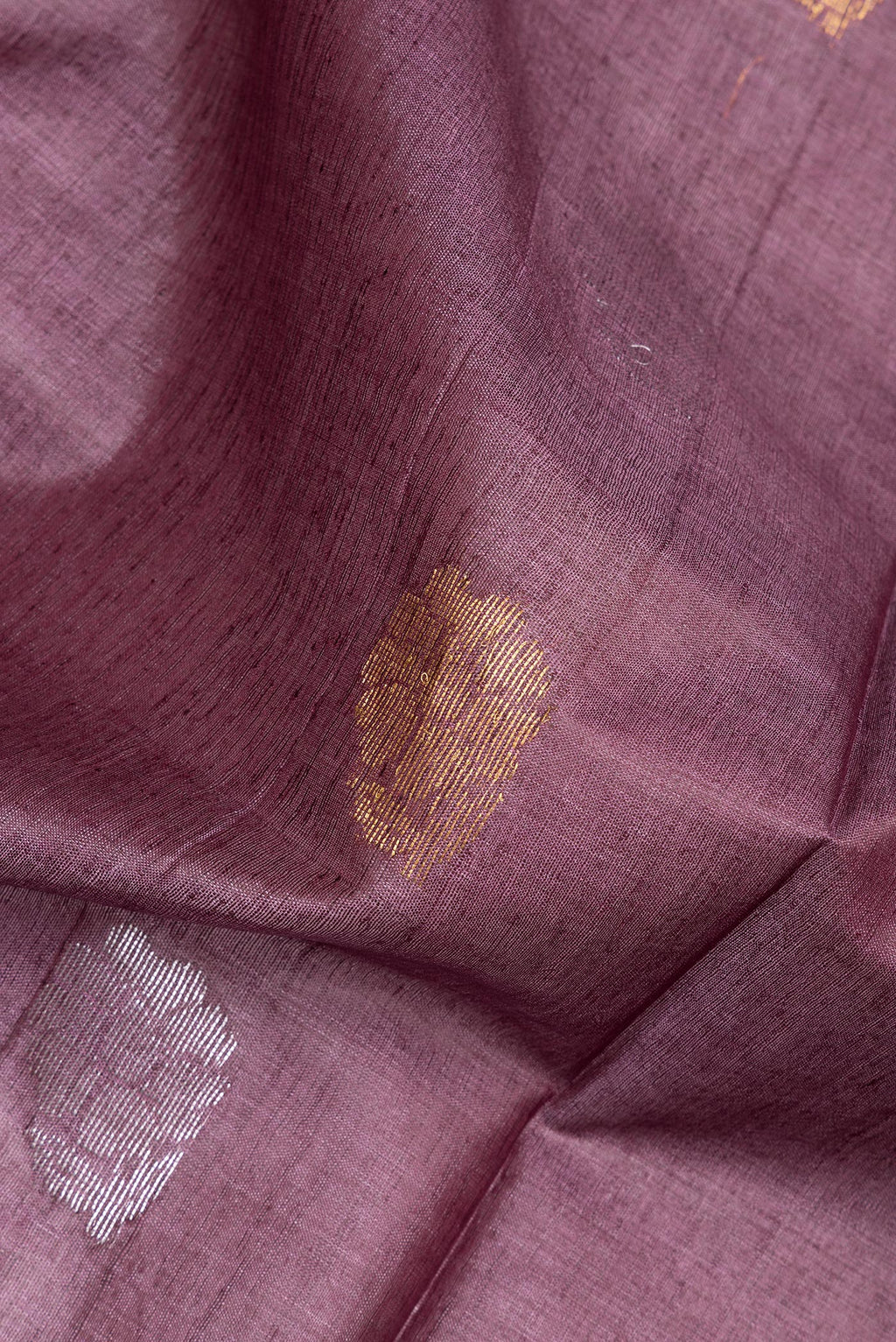 Close up of Pure Silk Purple Dual Tone Tussar Saree with Zari Butta on the body and Zari Border.  displaying folds