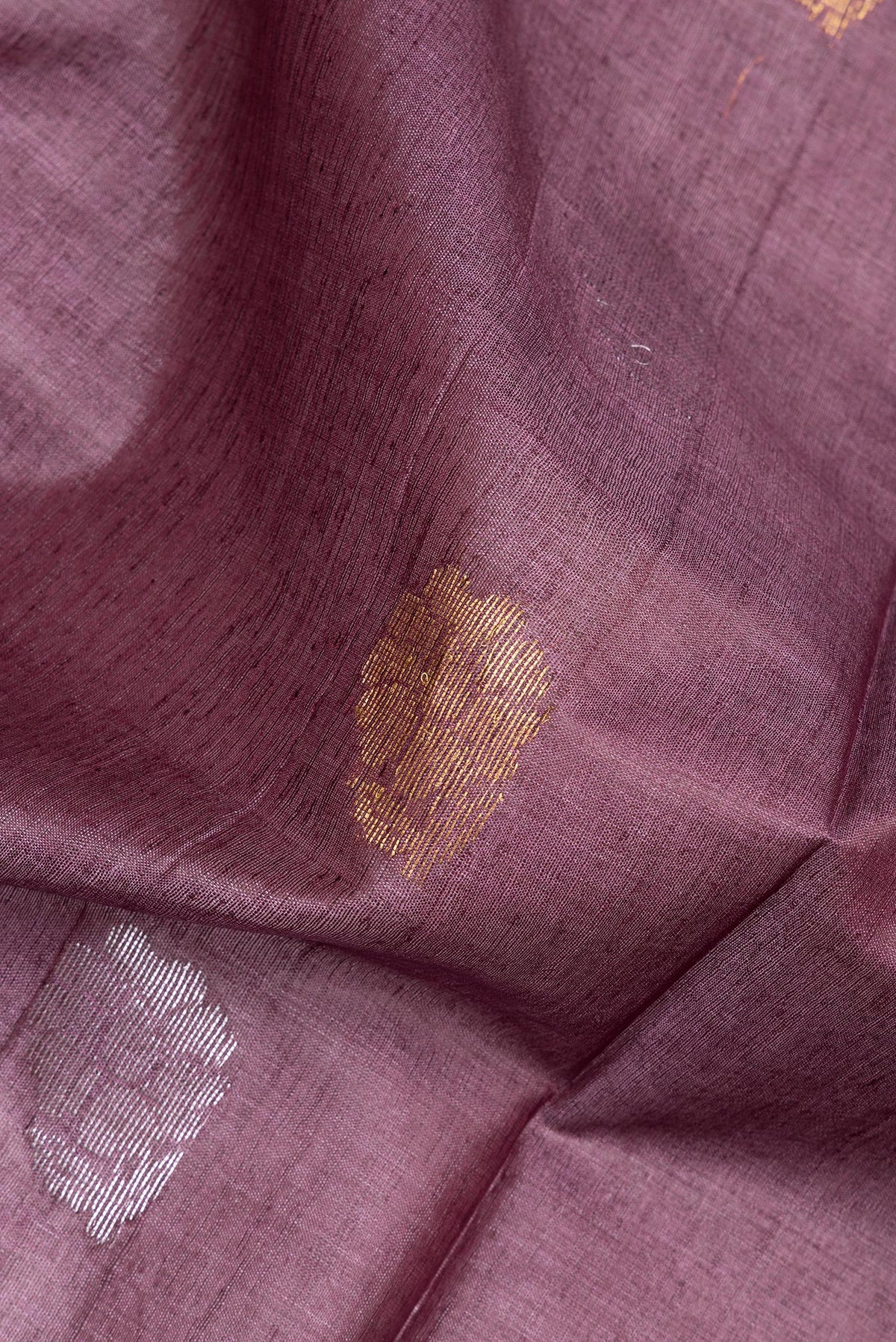 Close up of Pure Silk Purple Dual Tone Tussar Saree with Zari Butta on the body and Zari Border.  displaying folds
