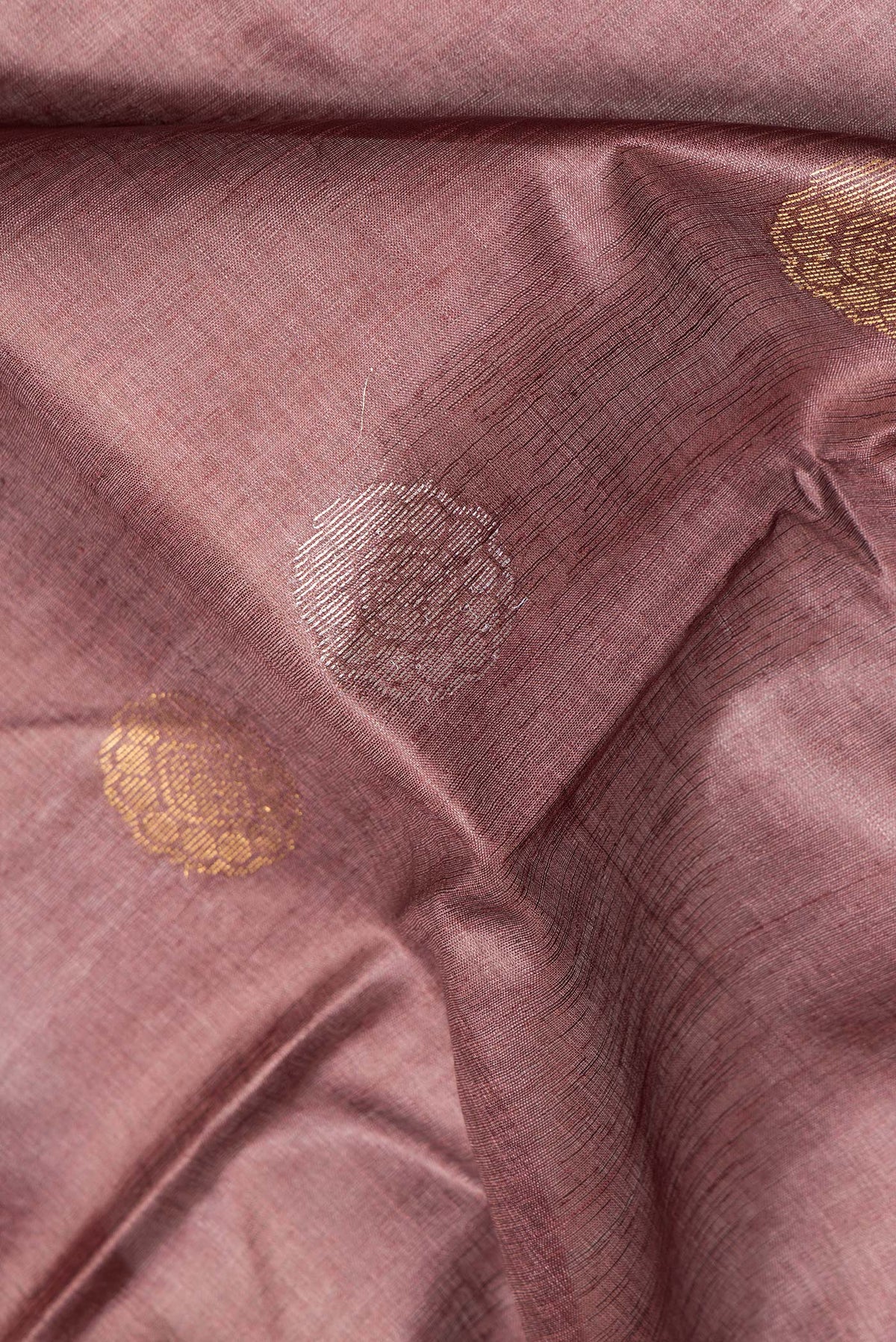 Close up of Pure Silk Coffee Brown Dual Tone Tussar Saree with Zari Butta on the body and Zari Border.  displaying folds