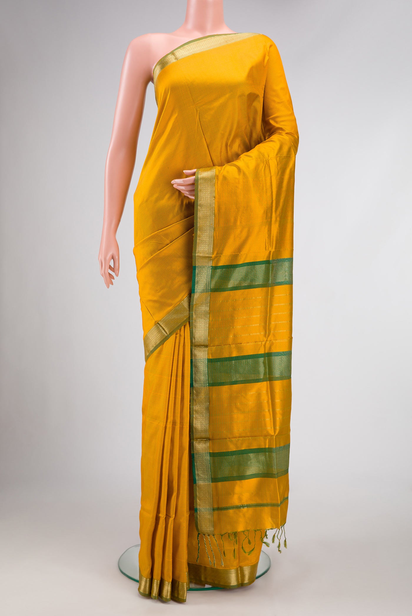 Mustard Dual Tone Maheshwari Silk Saree with Stripes on the body and Zari Border.  displayed on a mannequin