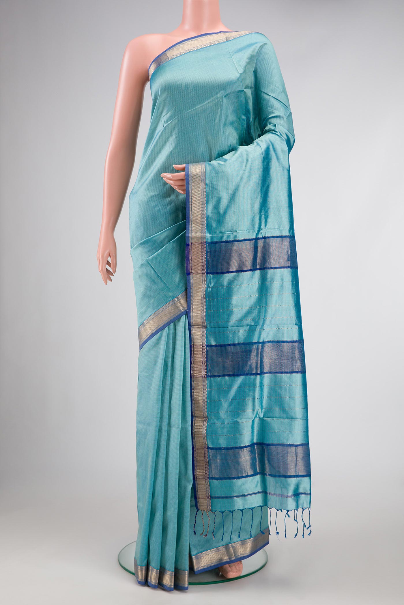 Maya Blue Dual Tone Maheshwari Silk Saree with Stripes on the body and Zari Border.  displayed on a mannequin