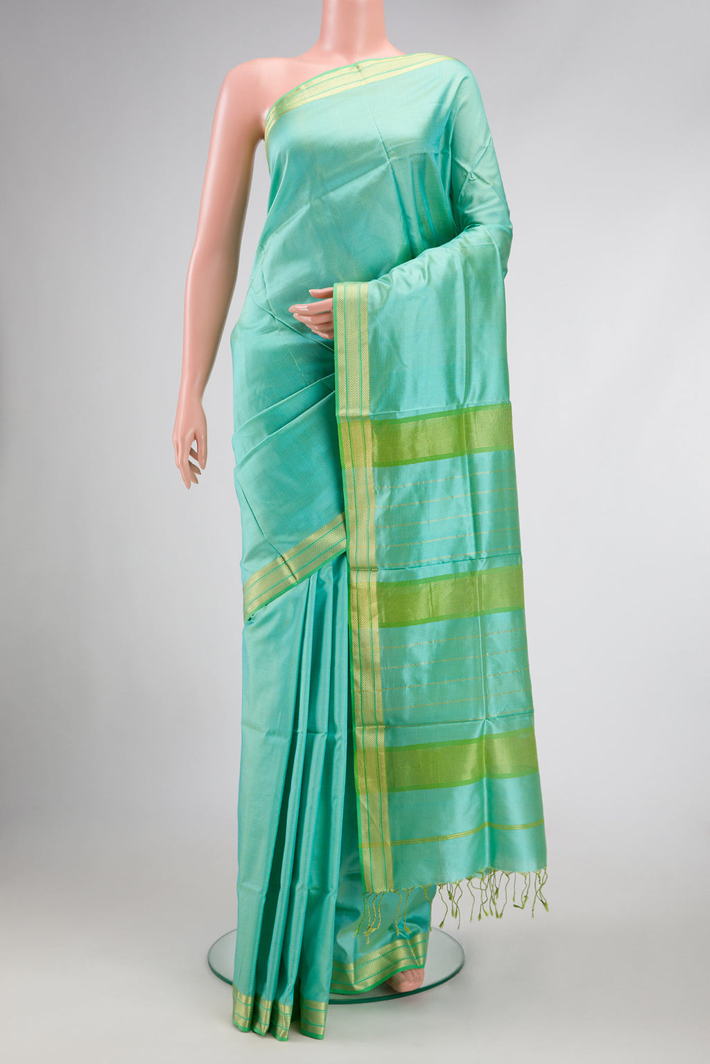 Sea Green Dual Tone Maheshwari Silk Saree with Stripes on the body and Zari Border.  displayed on a mannequin