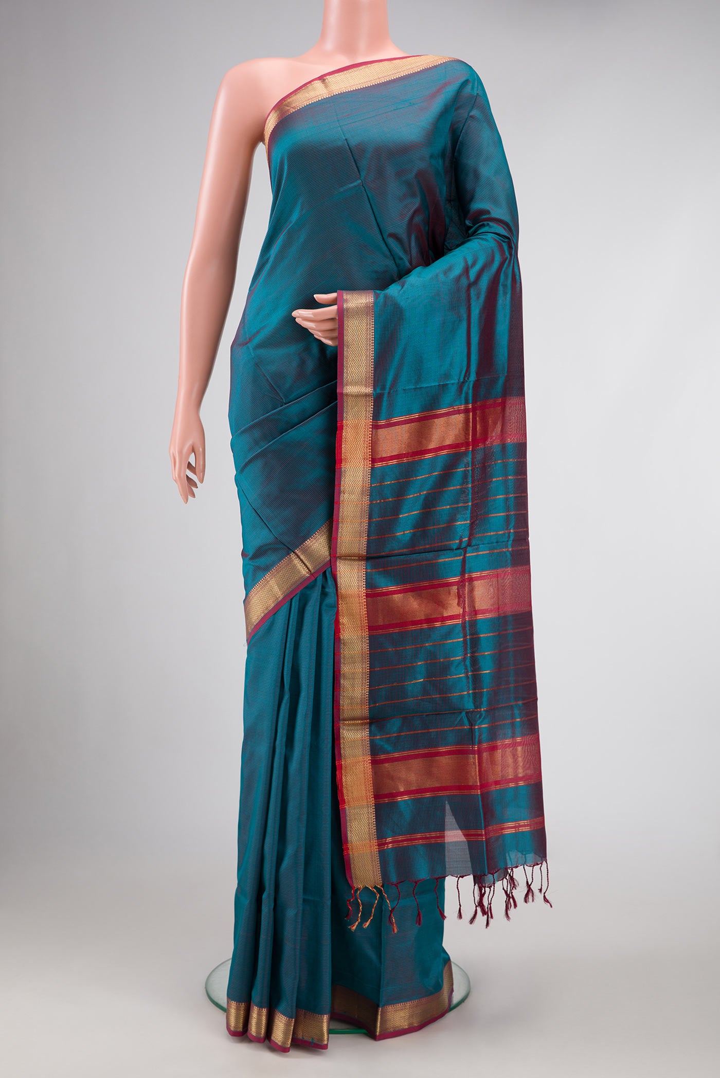 Peacock Blue Dual Tone Maheshwari Silk Saree with Stripes on the body and Zari Border.  displayed on a mannequin