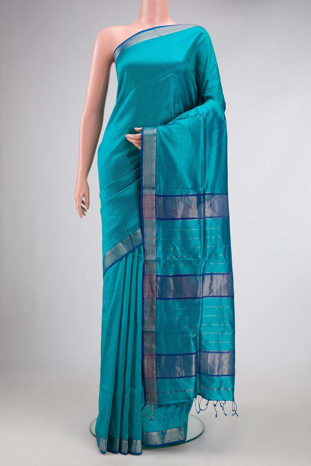 Peacock Blue Dual Tone Maheshwari Silk Saree with Stripes on the body and Zari Border.  displayed on a mannequin