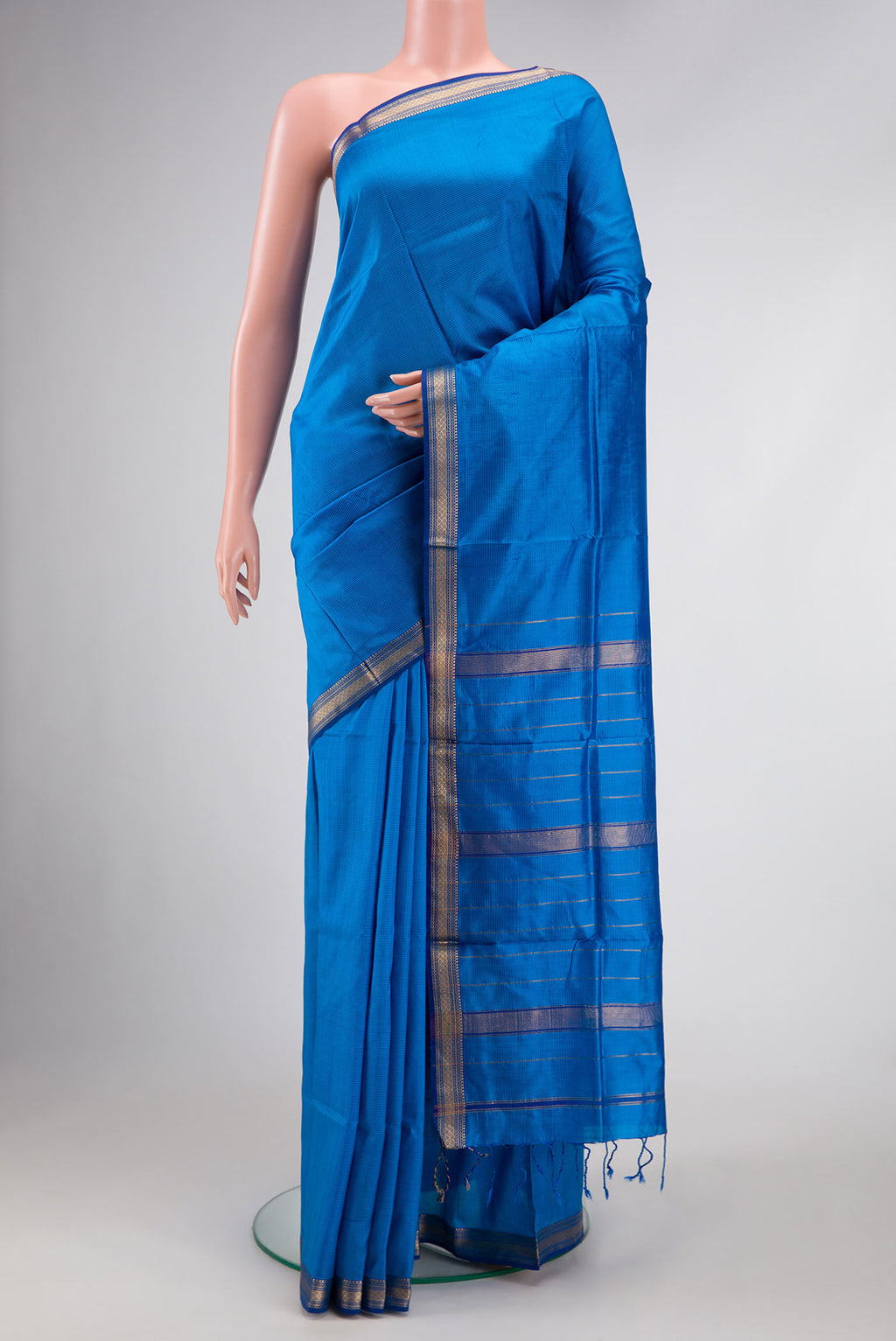 Royal Blue Dual Tone Maheshwari Silk Saree with Stripes on the body and Zari Border.  displayed on a mannequin