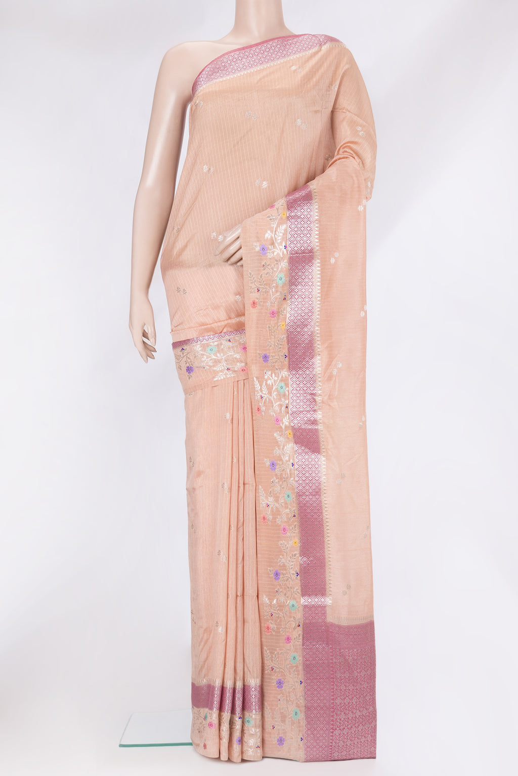 Peach Tussar Silk Saree with Zari Butta on the body and Fancy Border.  displayed on a mannequin