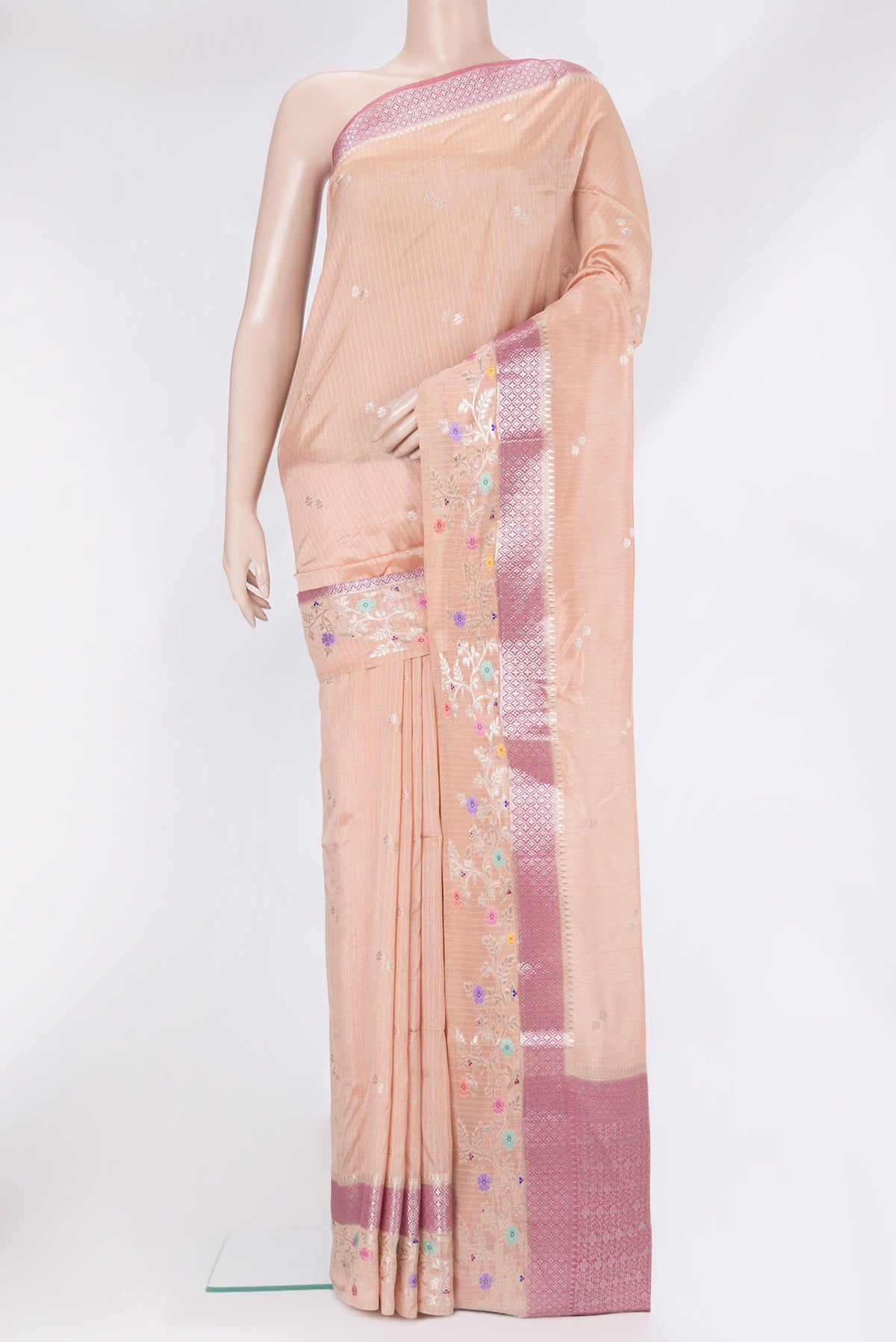 Peach Tussar Silk Saree with Zari Butta on the body and Fancy Border.  displayed on a mannequin
