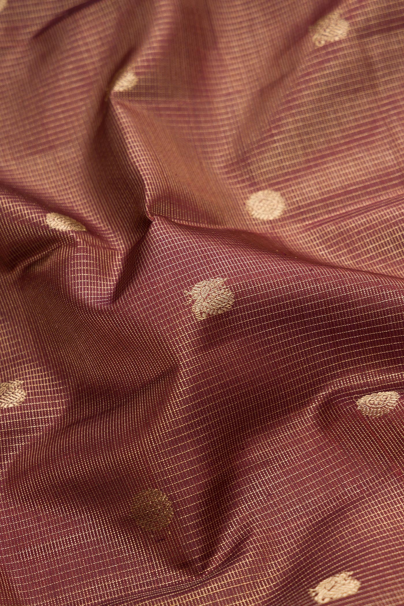 Close up of Pure Silk Pure Zari Maroon Dual Tone Kanchipuram Saree with Checked design on the body and Zari Border.  displaying folds