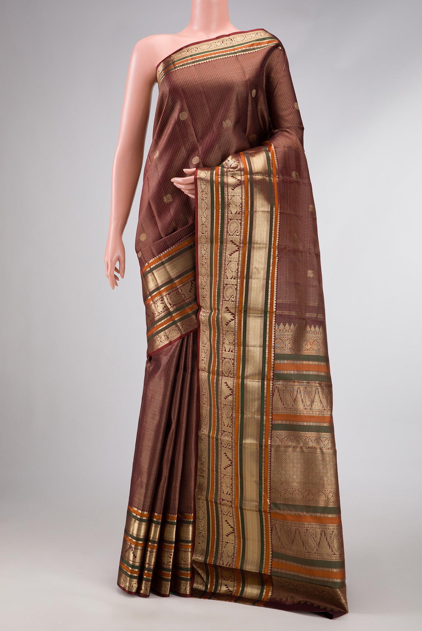 Pure Silk Pure Zari Maroon Dual Tone Kanchipuram Saree with Checked design on the body and Zari Border.  displayed on a mannequin