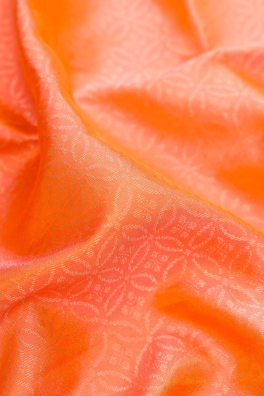Close up of Orange Dual Tone Soft Silk Saree with Zari Brocade on the body and Fancy Border.  displaying folds