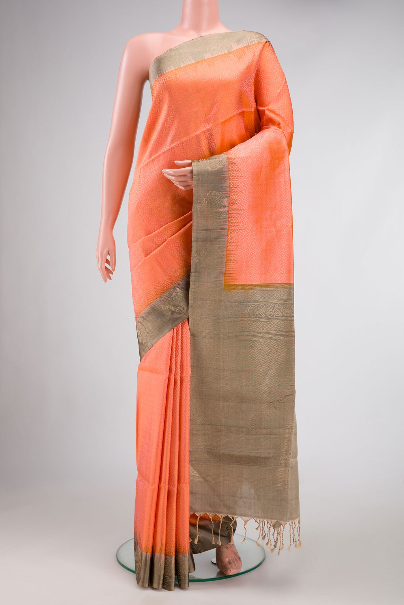 Orange Dual Tone Soft Silk Saree with Zari Brocade on the body and Fancy Border.  displayed on a mannequin