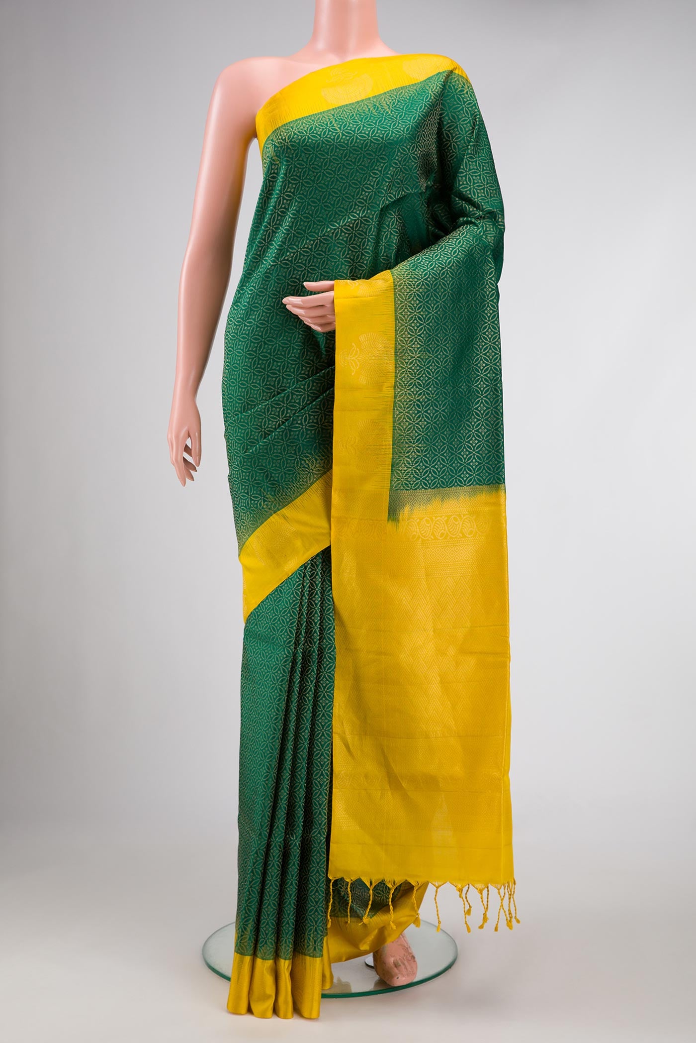 Bottle Green Dual Tone Soft Silk Saree with Zari Brocade on the body and Fancy Border.  displayed on a mannequin