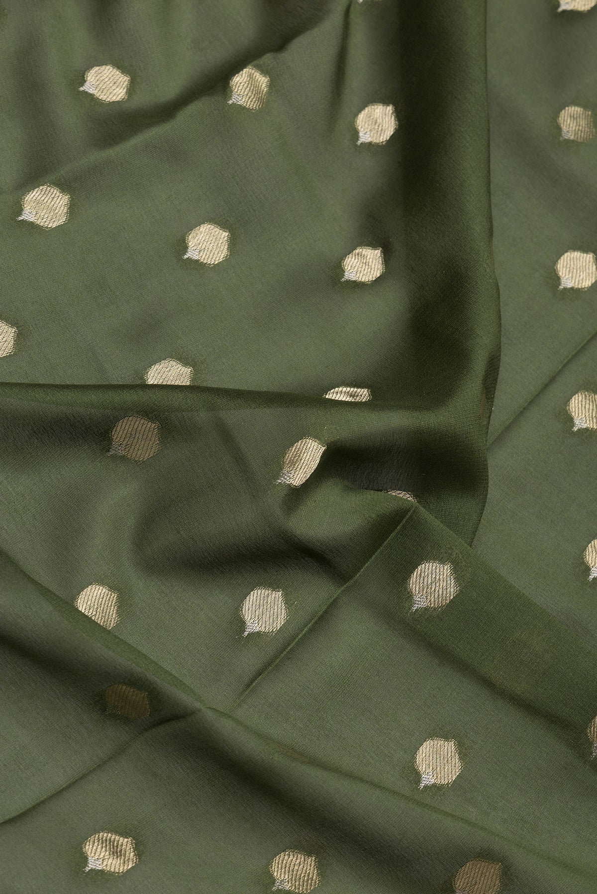 Close up of Mehandi Green Dual Tone Mysore Crepe Saree with Zari Butta on the body and Zari Border.  displaying folds