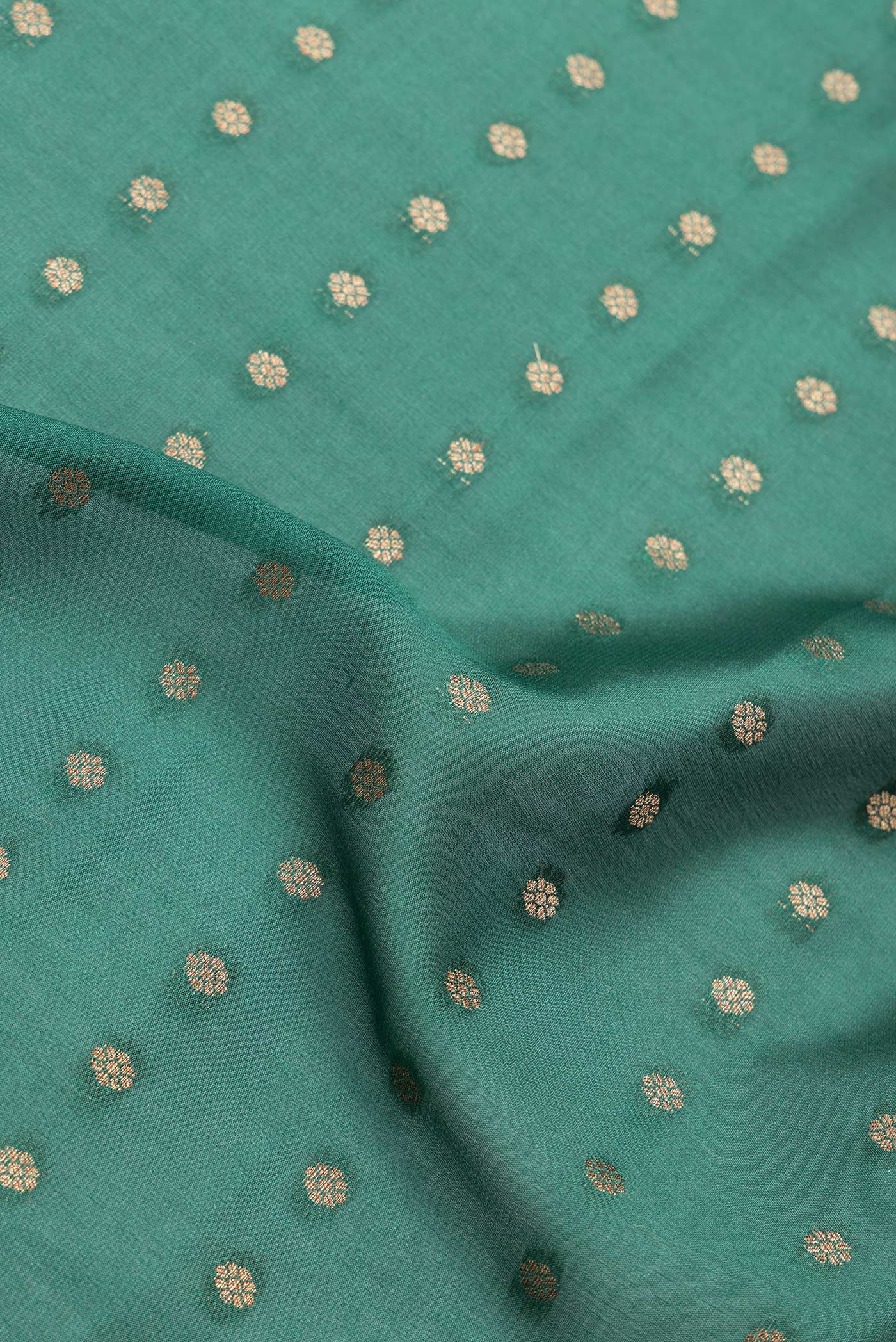 Close up of Bottle Green Dual Tone Banarasi Georgette Saree with Zari Butta on the body and Zari Border.  displaying folds