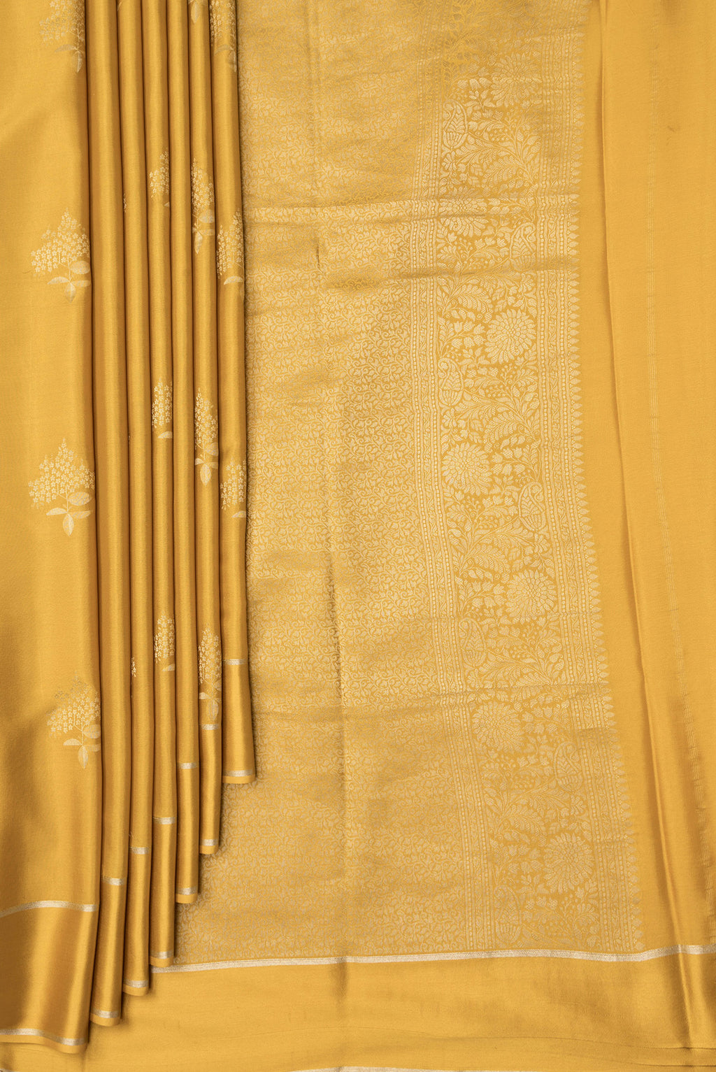 Pleats and pallu of Mustard Dual Tone Mysore Crepe Saree with Zari Butta on the body and Zari Border. 