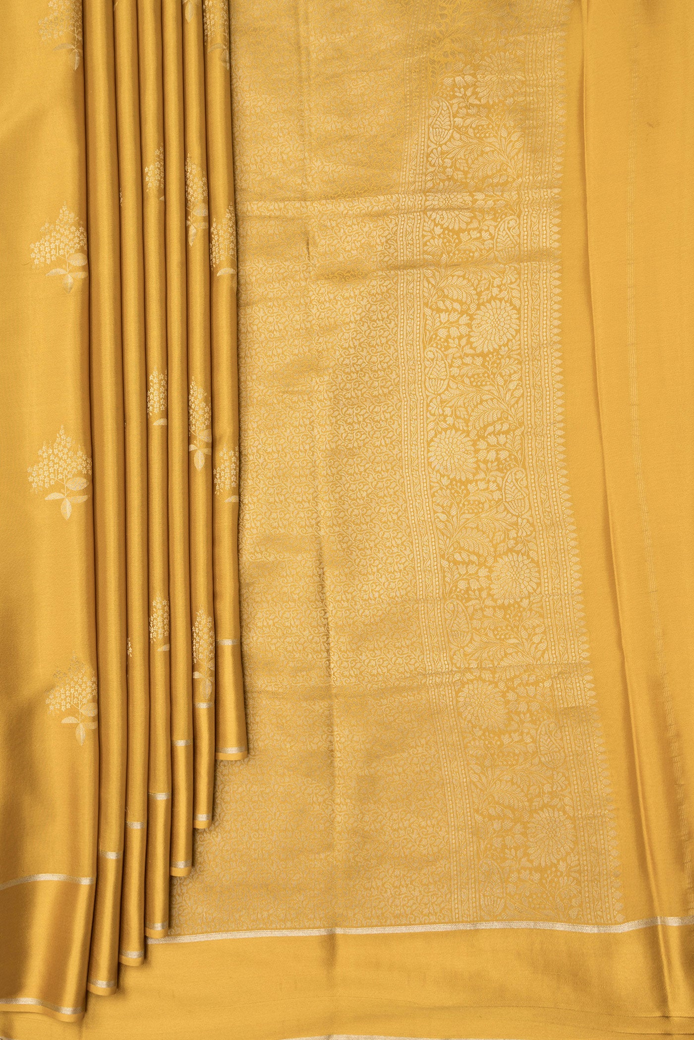 Pleats and pallu of Mustard Dual Tone Mysore Crepe Saree with Zari Butta on the body and Zari Border. 