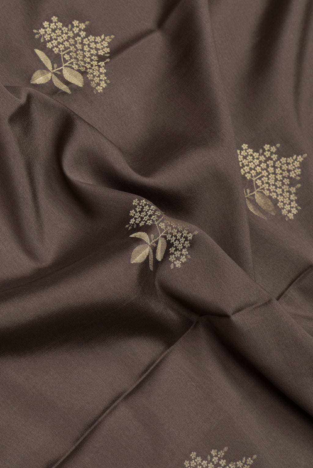 Close up of Brown Dual Tone Mysore Crepe Saree with Zari Butta on the body and Zari Border.  displaying folds