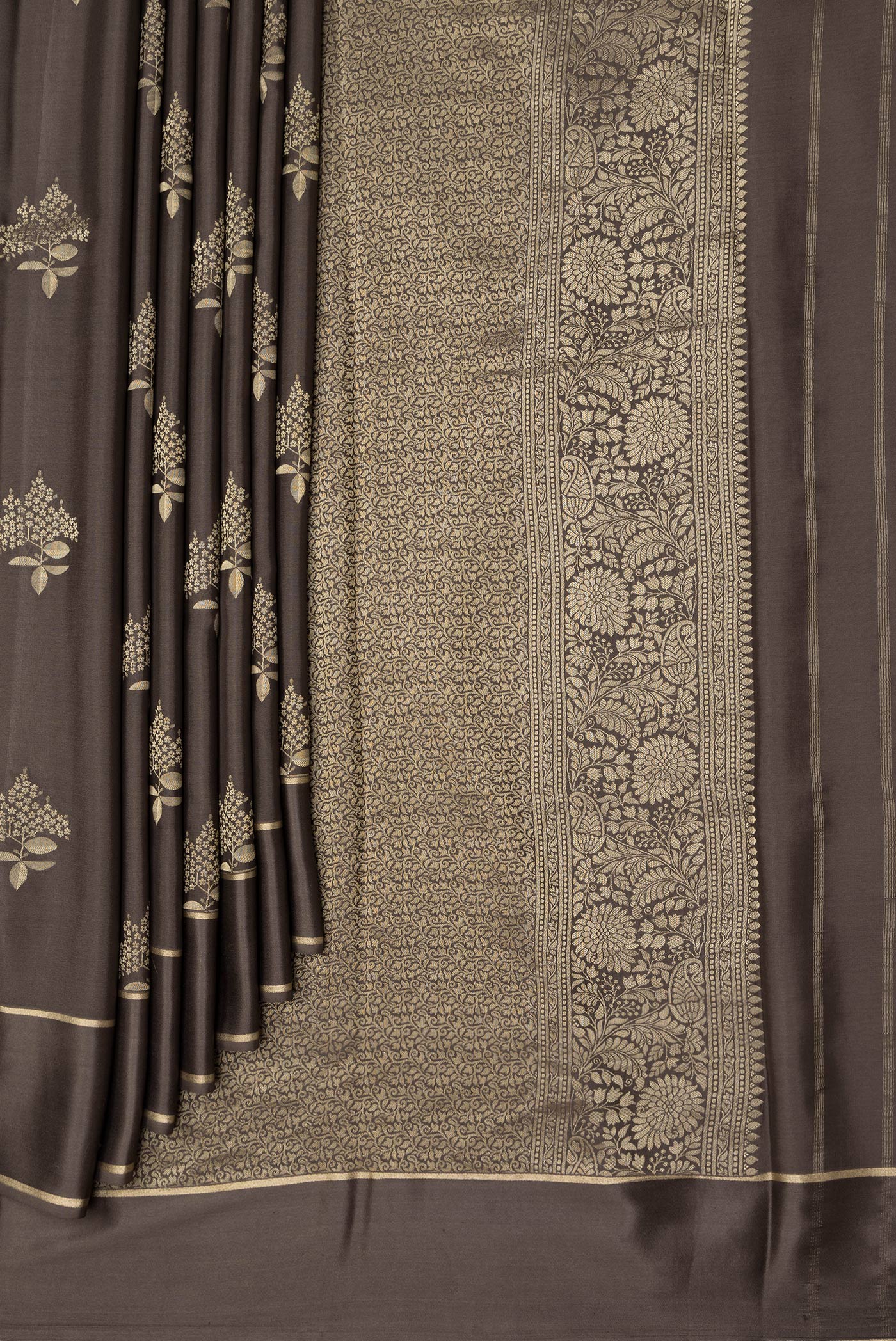 Pleats and pallu of Brown Dual Tone Mysore Crepe Saree with Zari Butta on the body and Zari Border. 