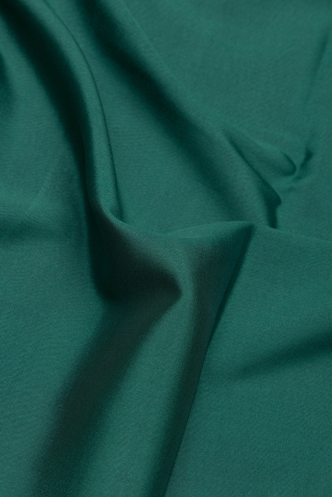 Close up of Bottle Green Dual Tone Mysore Silk Saree with Plain Body and Fancy Border.  displaying folds