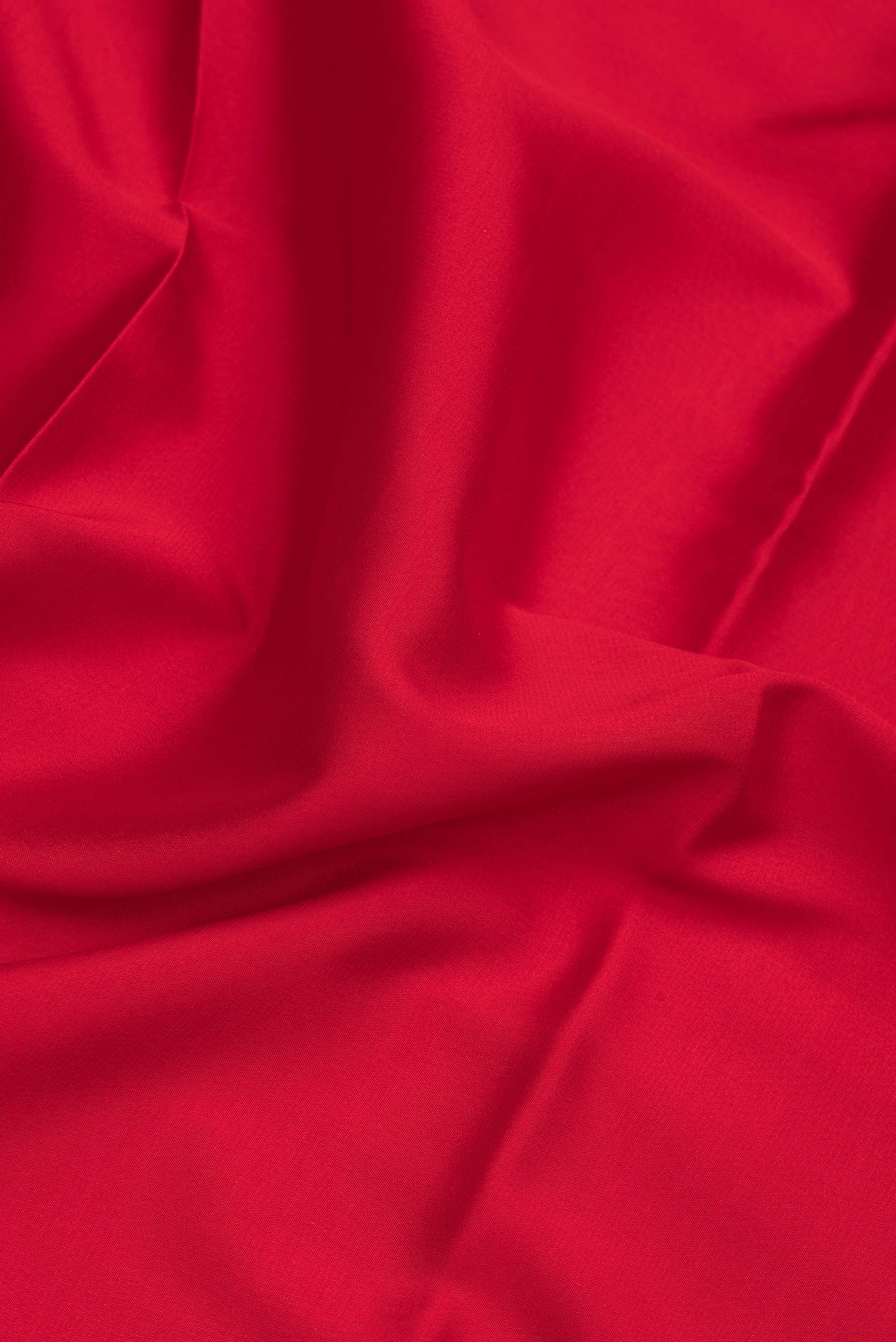 Close up of Red Mysore Silk Saree with Plain Body and Fancy Border.  displaying folds