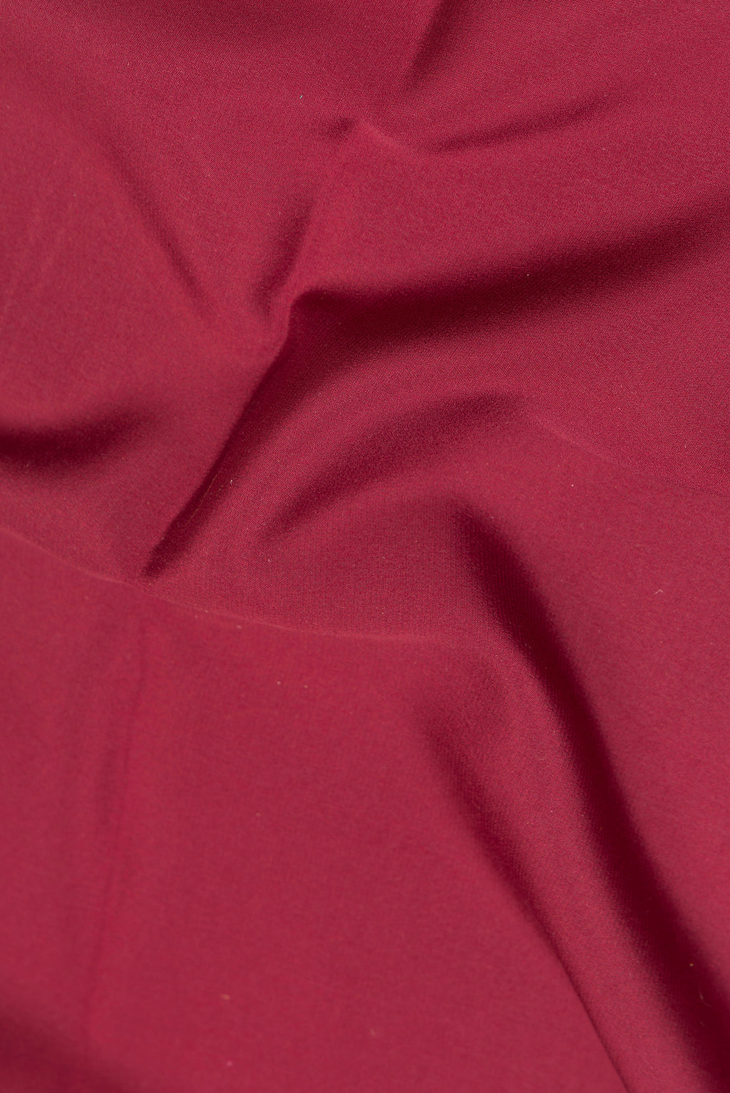 Close up of Maroon Mysore Crepe Saree with Plain Body and Zari Border.  displaying folds