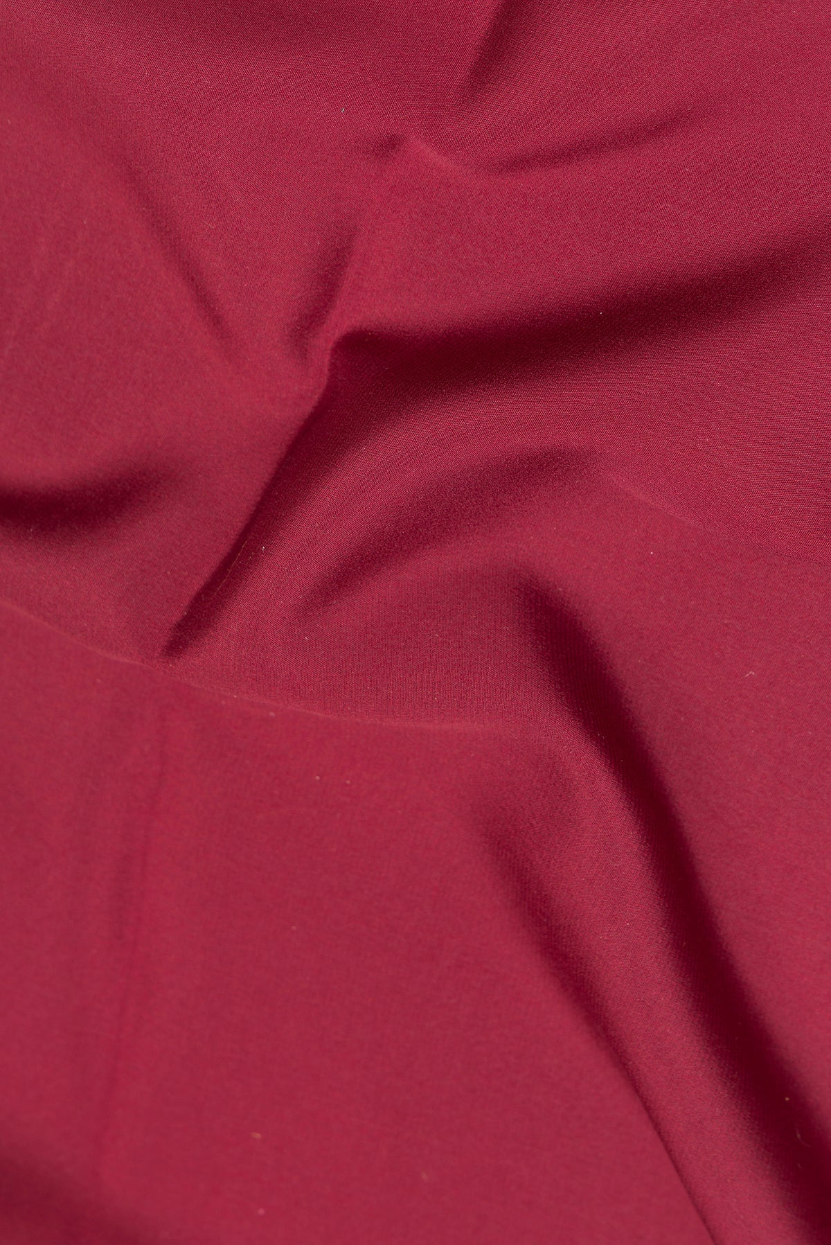 Close up of Maroon Mysore Crepe Saree with Plain Body and Zari Border.  displaying folds
