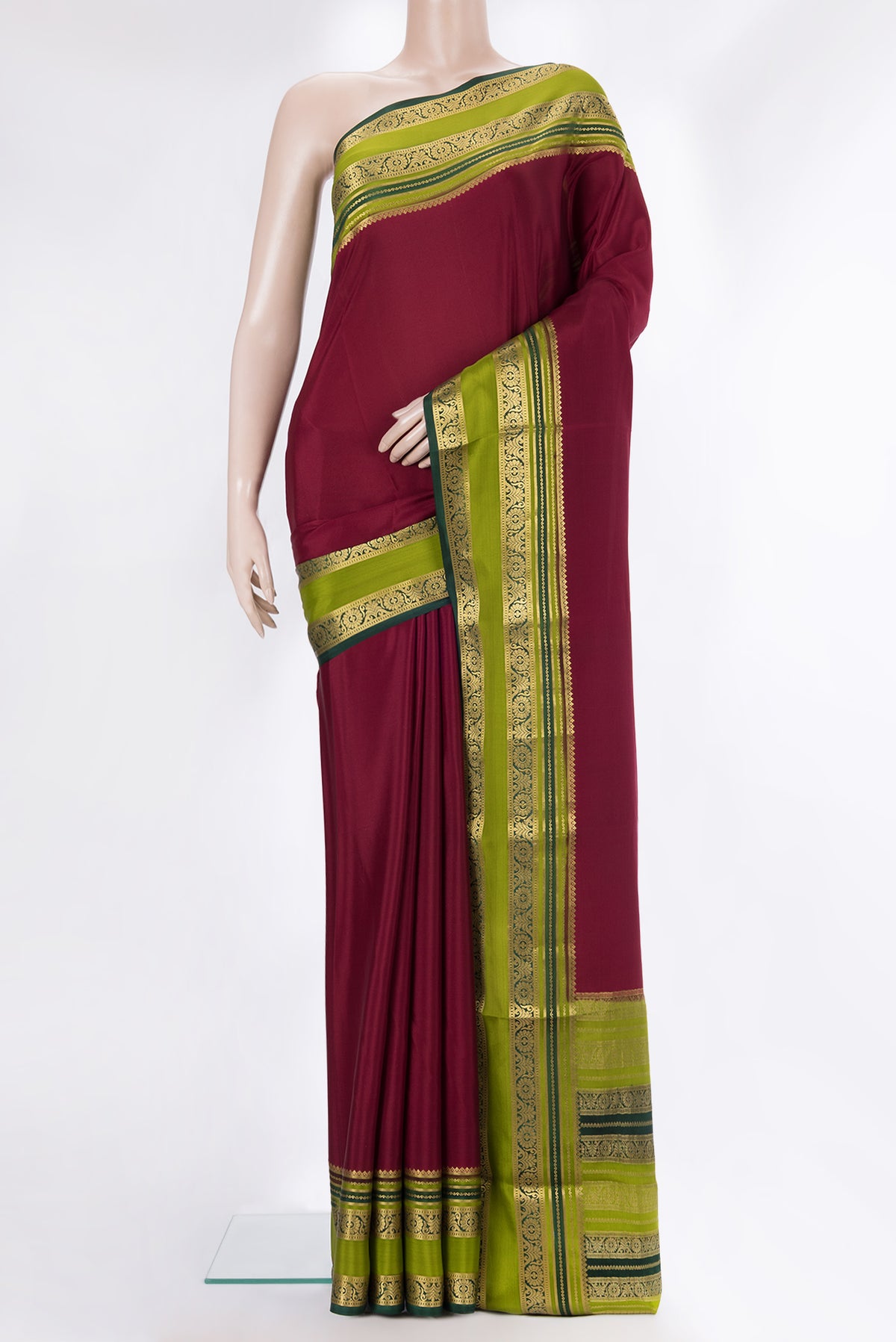 Maroon Mysore Crepe Saree with Plain Body and Zari Border.  displayed on a mannequin