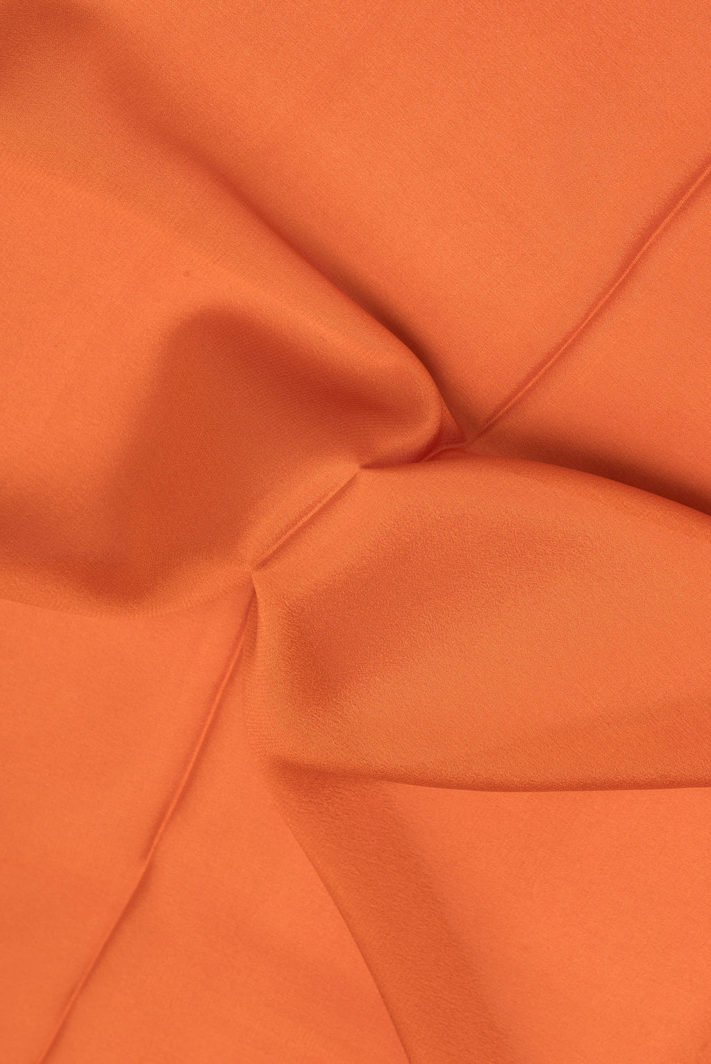 Close up of Brick Orange Mysore Silk Saree with Plain Body and Zari Border.  displaying folds