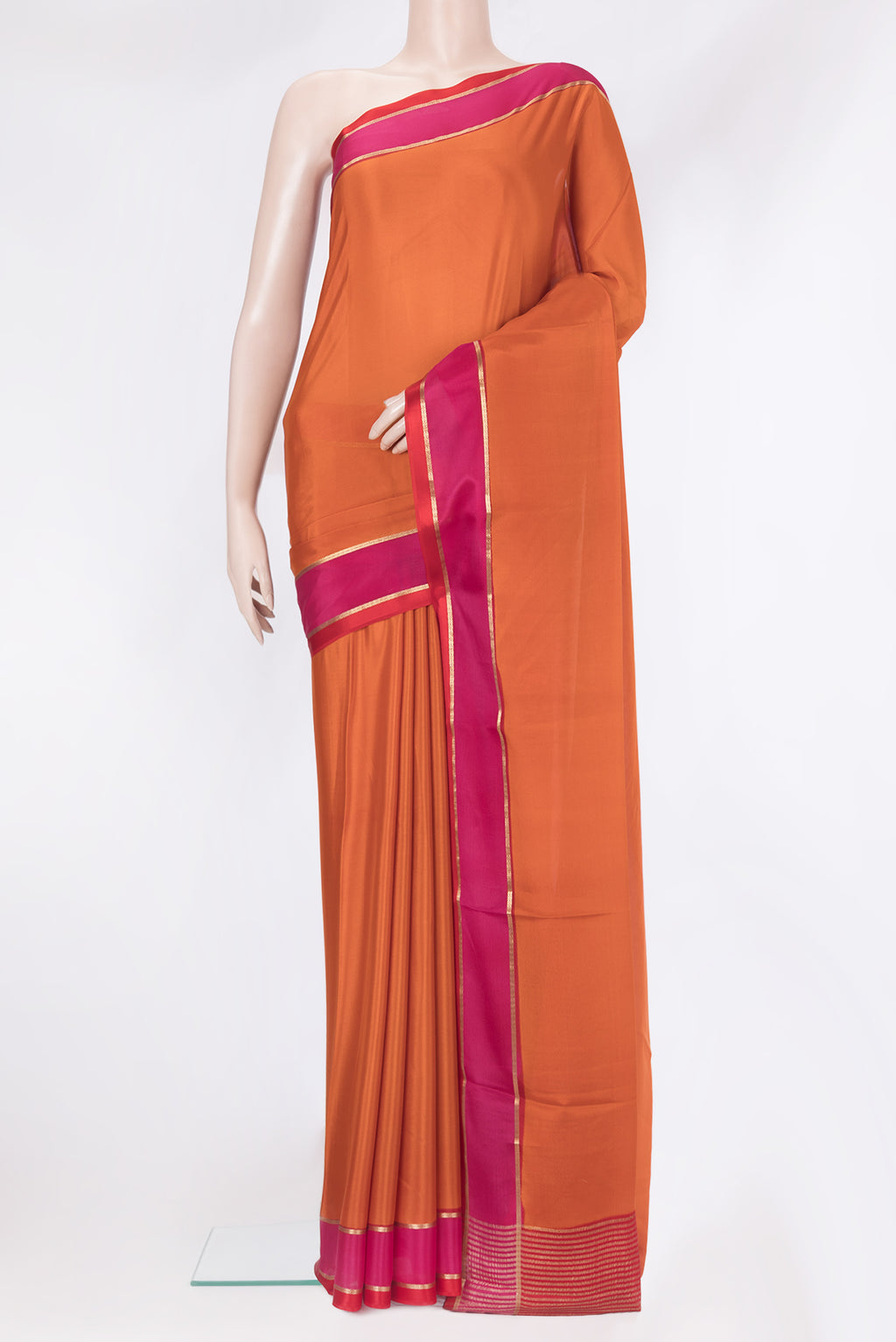 Brick Orange Mysore Silk Saree with Plain Body and Zari Border.  displayed on a mannequin