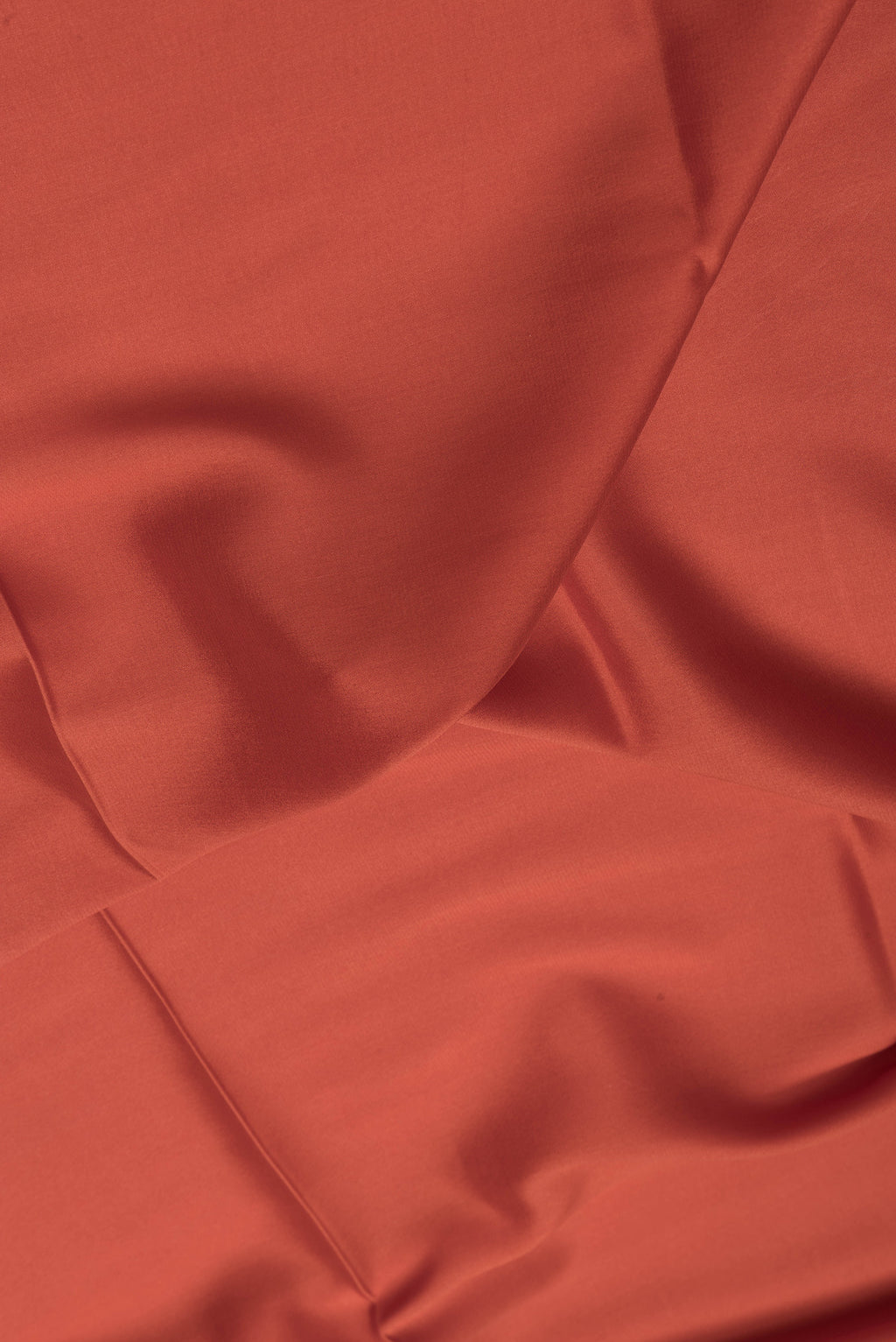Close up of Orange Dual Tone Mysore Silk Saree with Plain Body and Zari Border.  displaying folds