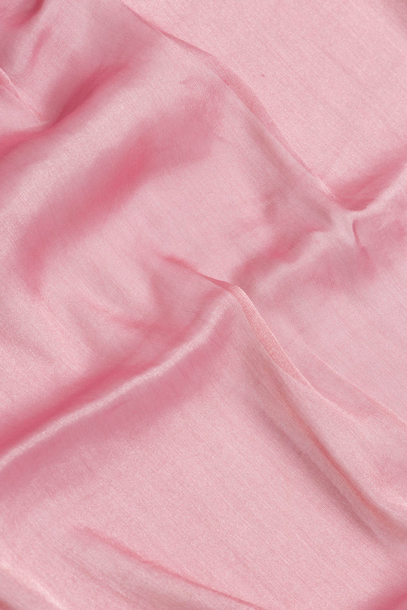 Close up of Pink Dual Tone Georgette Saree with Plain Body and Fancy Border.  displaying folds