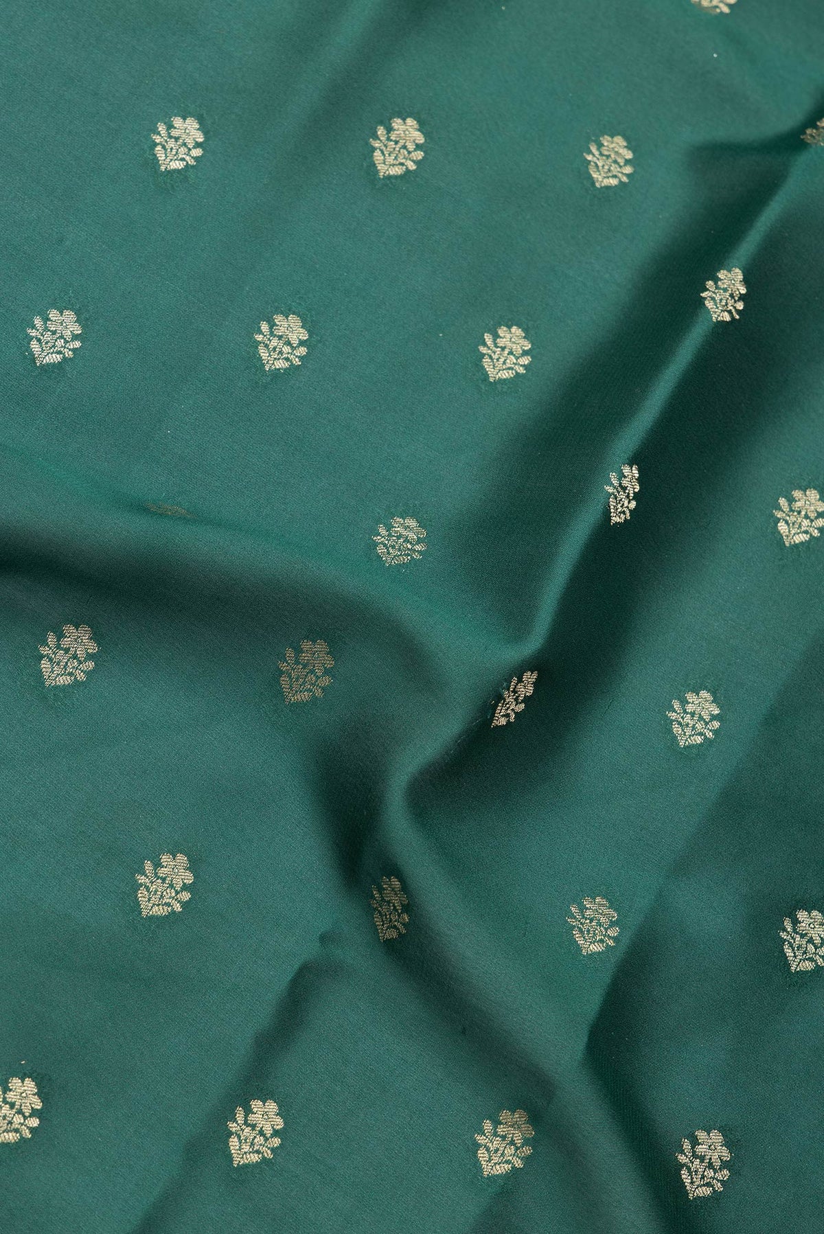 Close up of Bottle Green Dual Tone Mysore Georgette Saree with Zari Butta on the body and Zari Border.  displaying folds