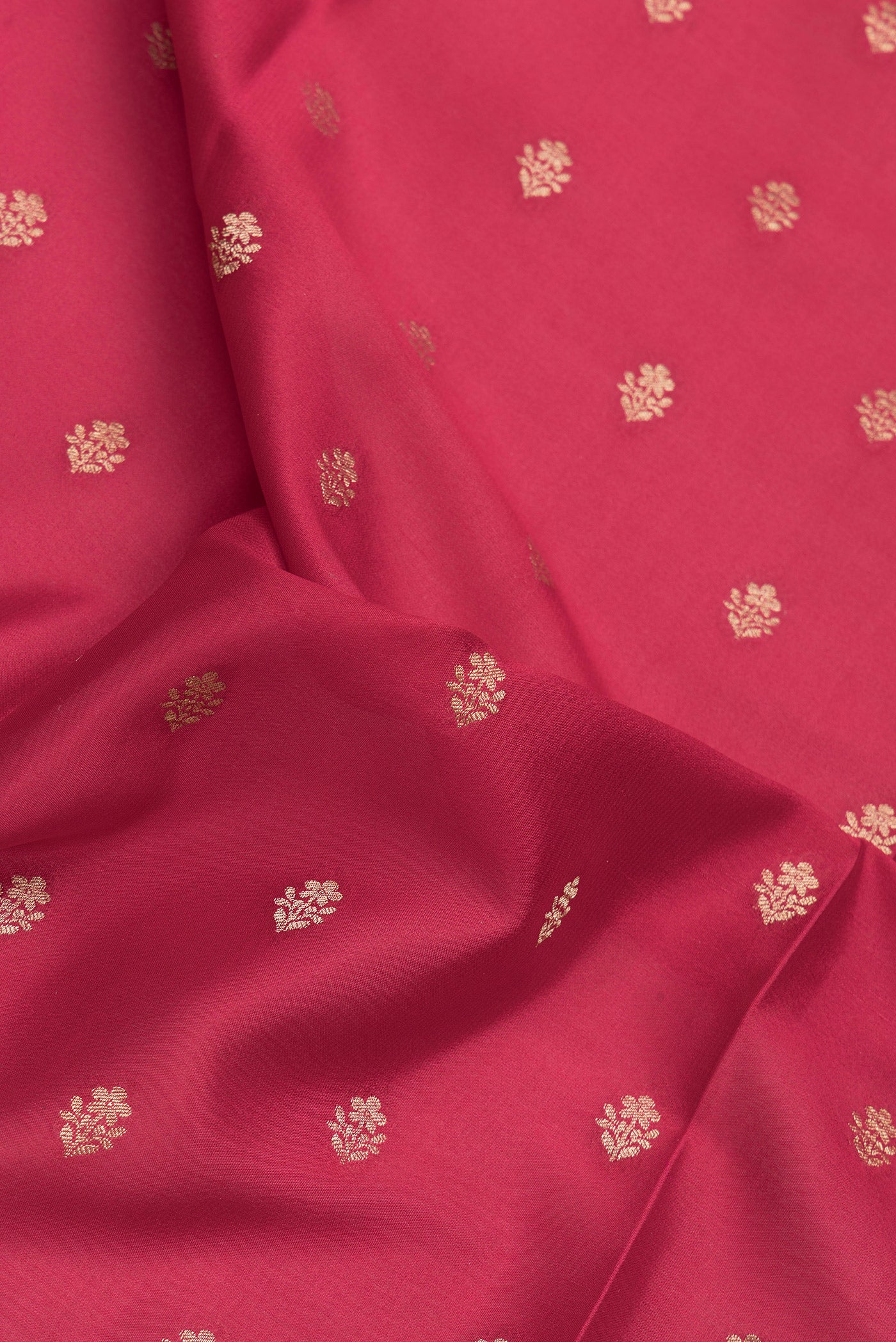 Close up of Red Mysore Crepe Saree with Zari And Thread Butta on the body and Zari Border.  displaying folds