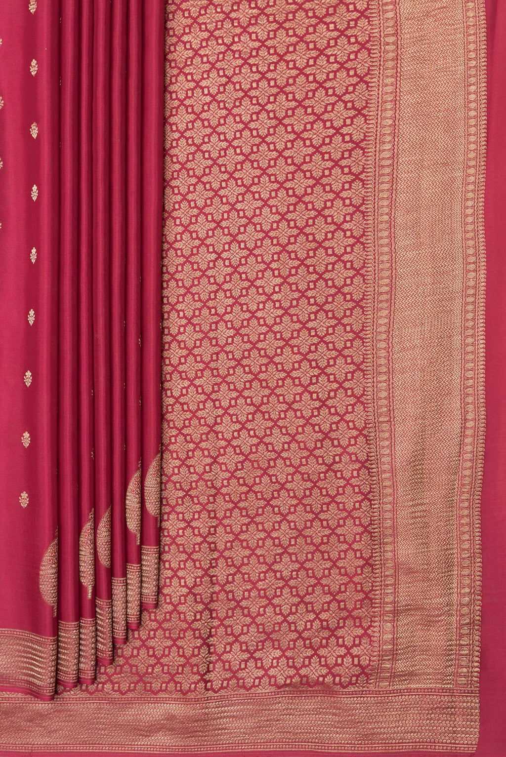 Pleats and pallu of Red Mysore Crepe Saree with Zari And Thread Butta on the body and Zari Border. 