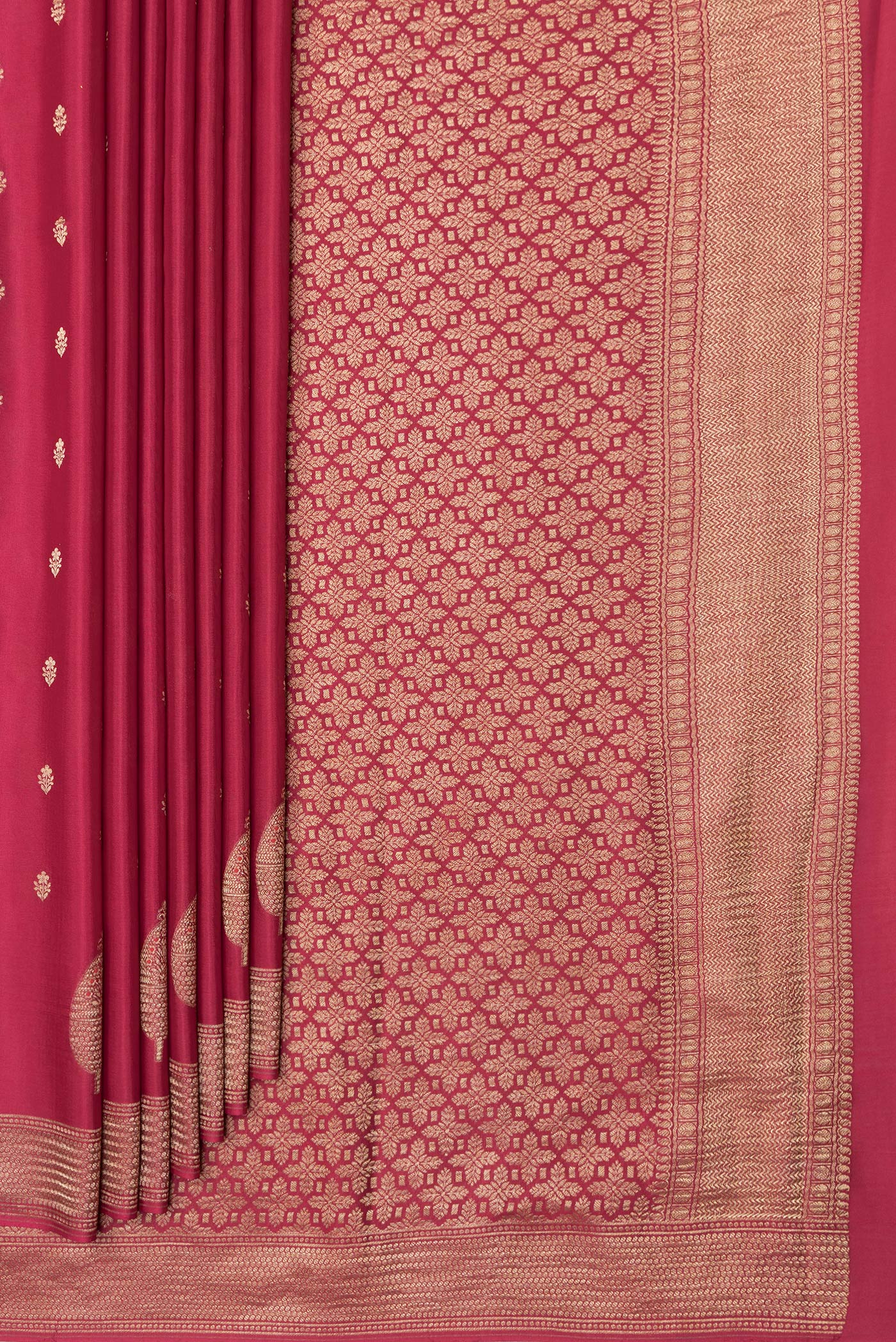 Pleats and pallu of Red Mysore Crepe Saree with Zari And Thread Butta on the body and Zari Border. 