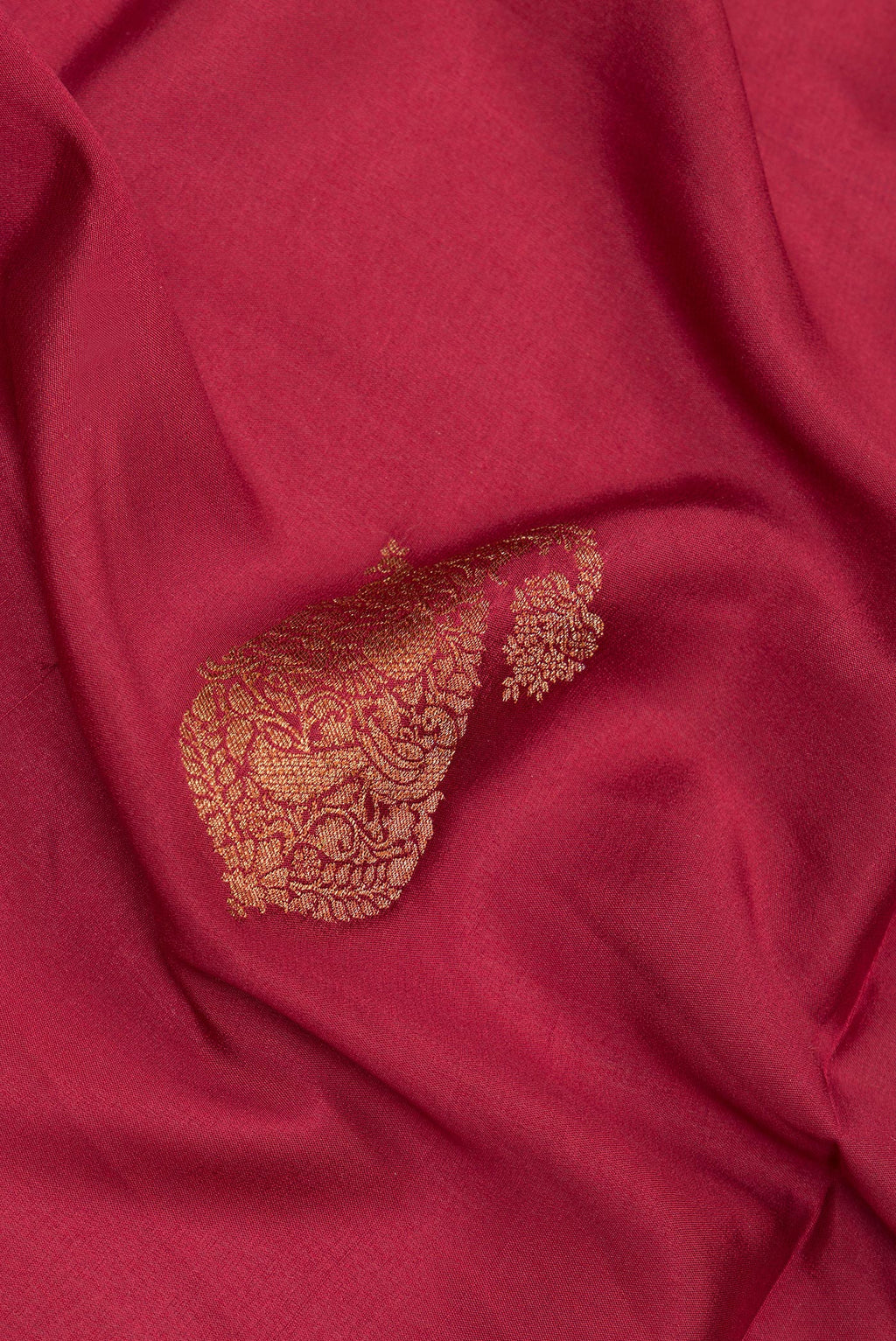 Close up of Maroon Crepe Saree with Zari Butta on the body and Zari Border.  displaying folds