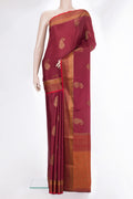 Maroon Crepe Saree with Zari Butta on the body and Zari Border.  displayed on a mannequin