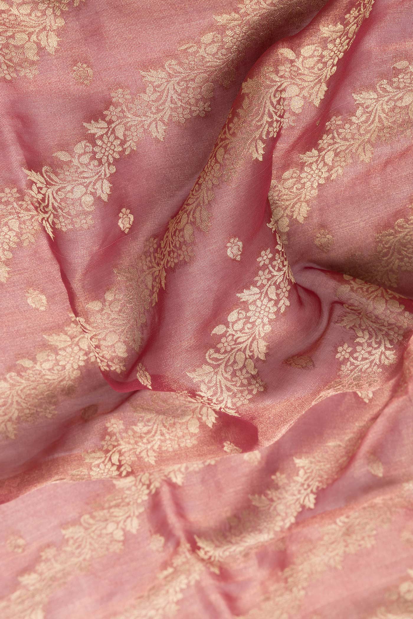Close up of Dark Pink Dual Tone Georgette Saree with Zari Brocade on the body and Zari Border.  displaying folds