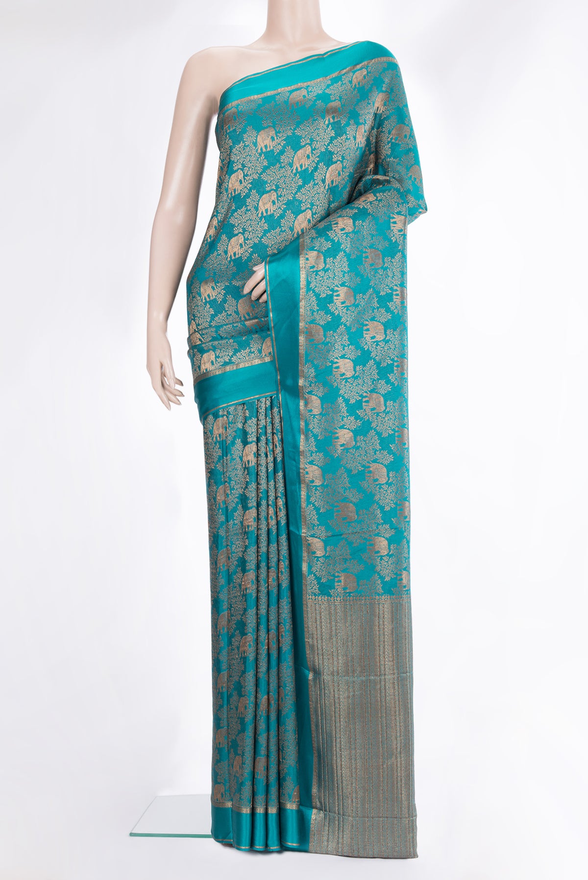 Teal Mysore Crepe Saree with Zari Brocade on the body and Zari And Thread Border.  displayed on a mannequin
