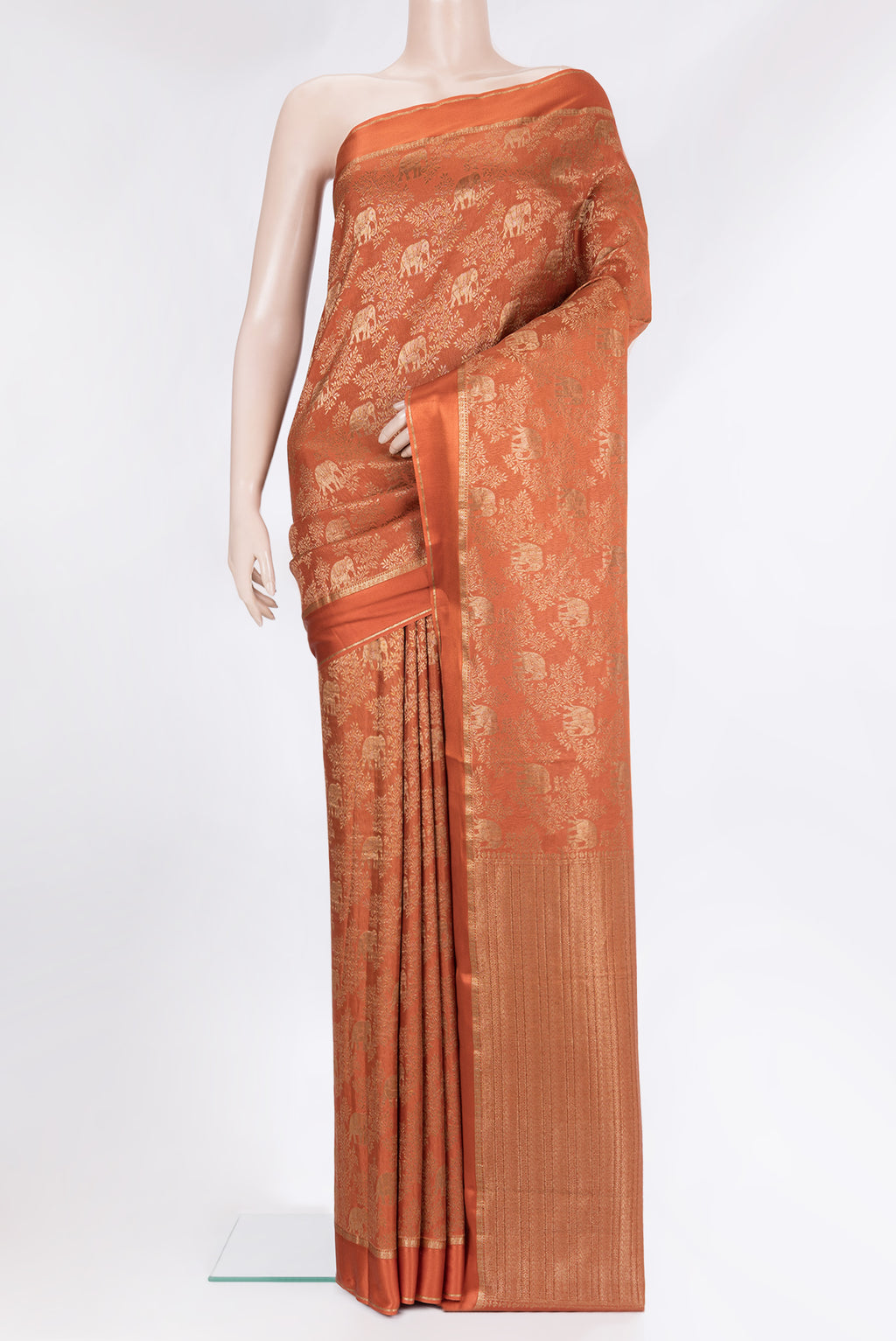 Rust Georgette Saree with Zari Brocade on the body and Zari Border.  displayed on a mannequin